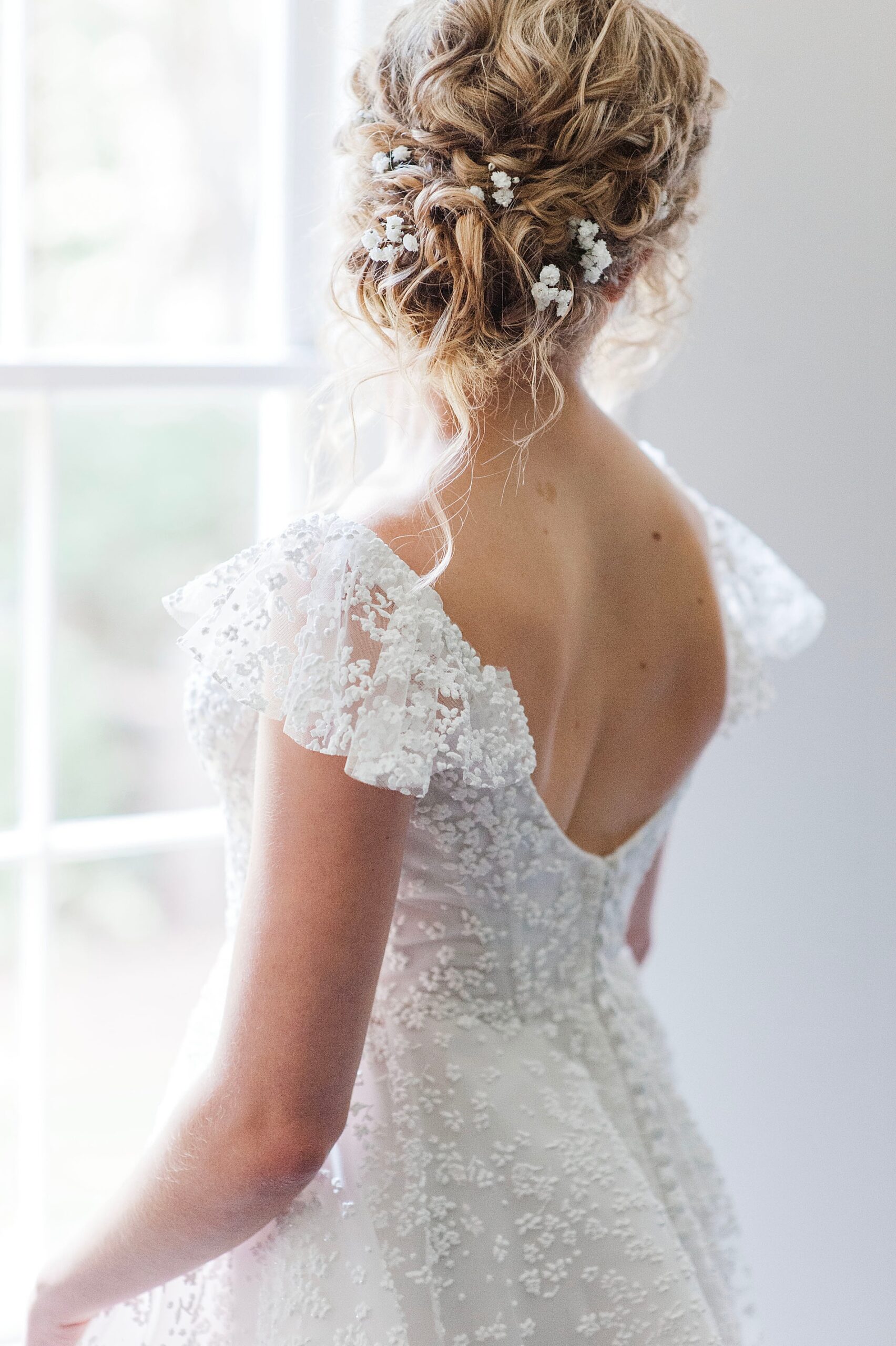 back of bride's wedding dress and hair style