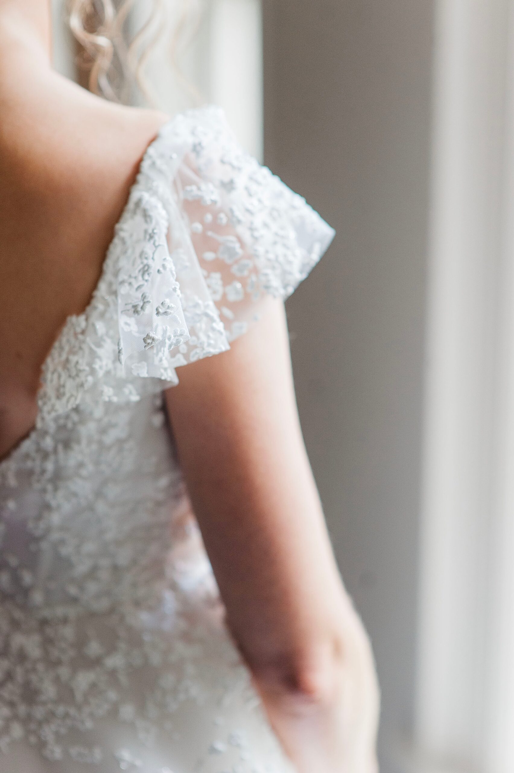 intricate details on bride's wedding dress