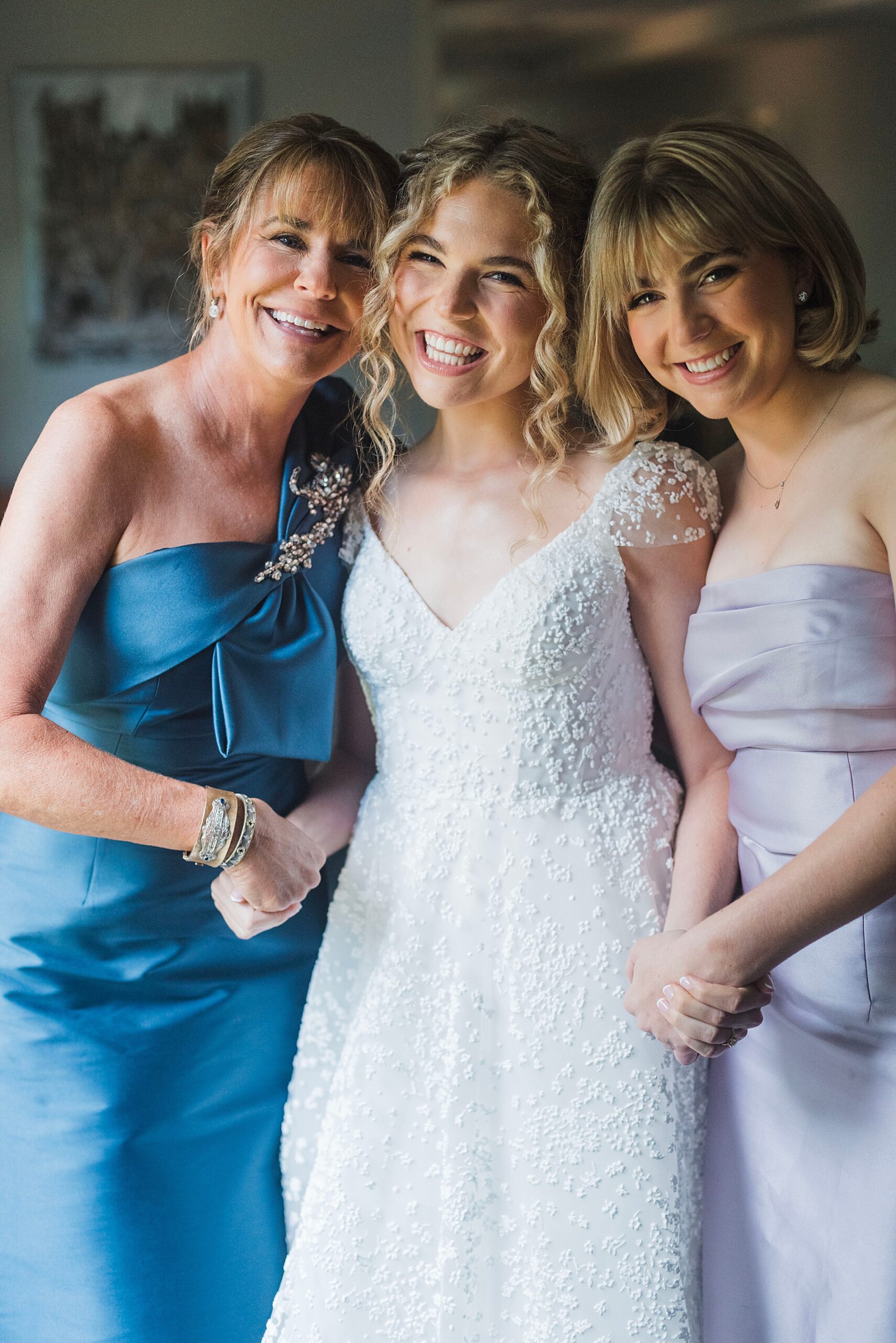 bride with mom and bridesmaid