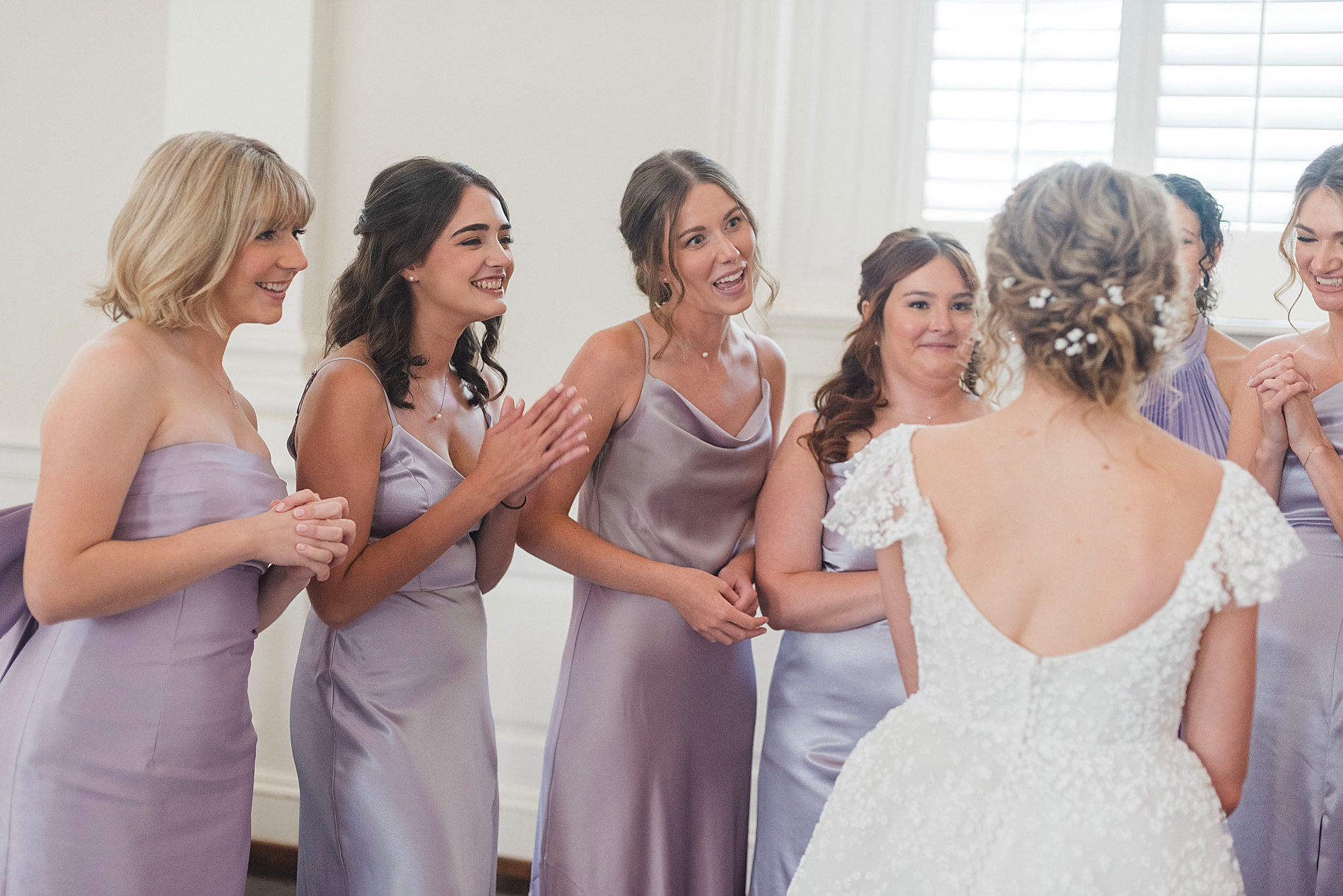 candid moments during first look with bridesmaids