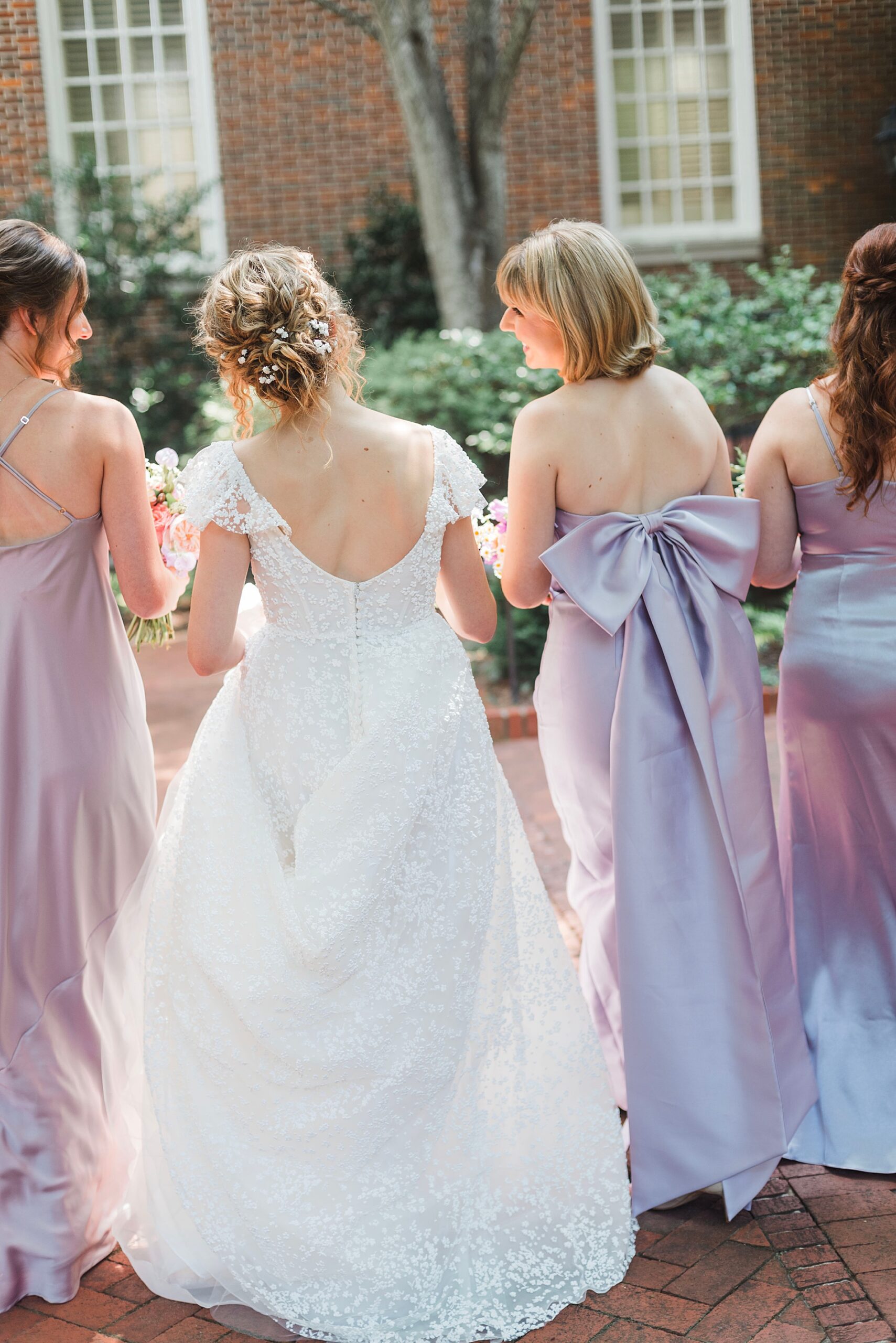 back of bride and bridesmaids' wedding dresses