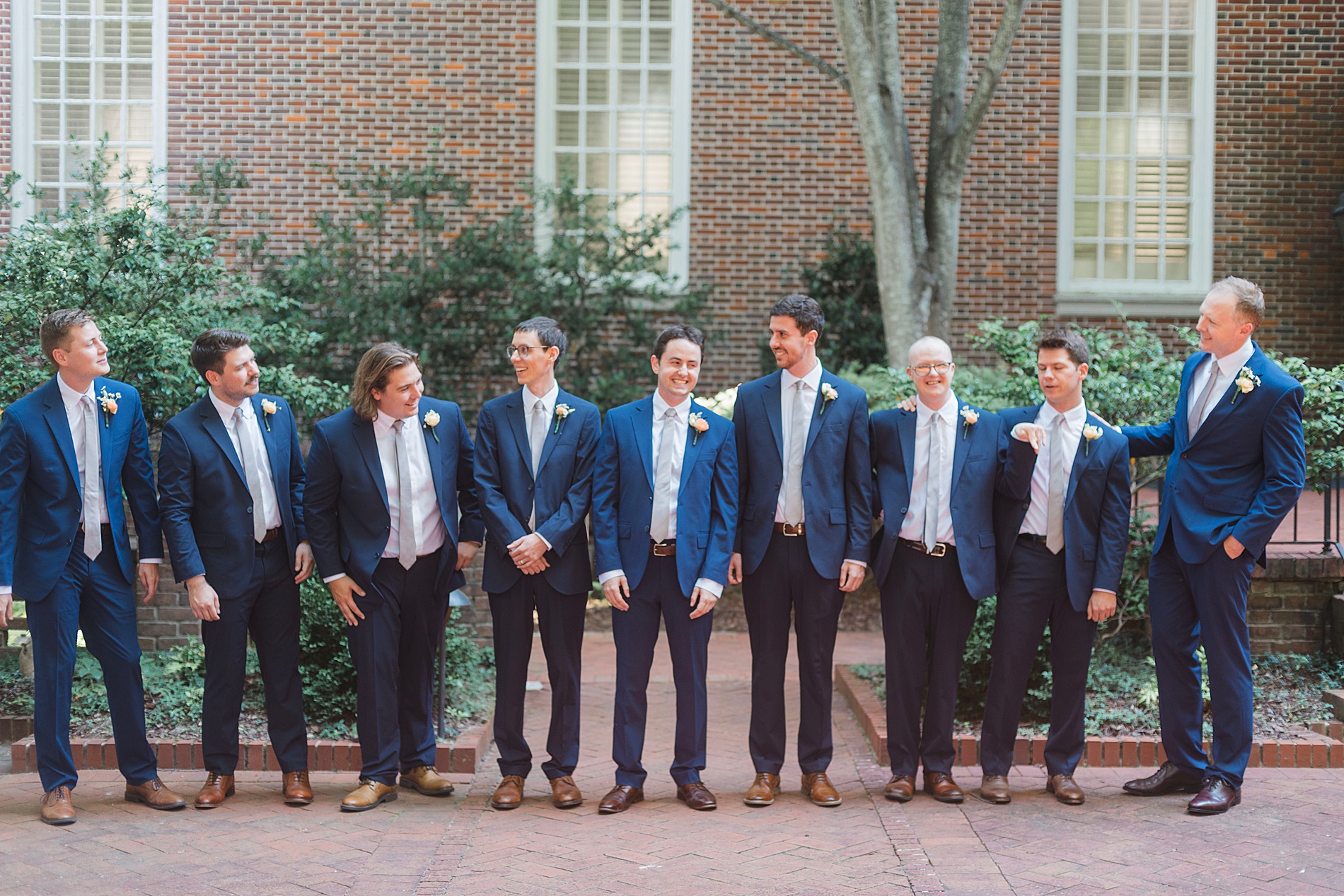 groomsmen with groom outside of church