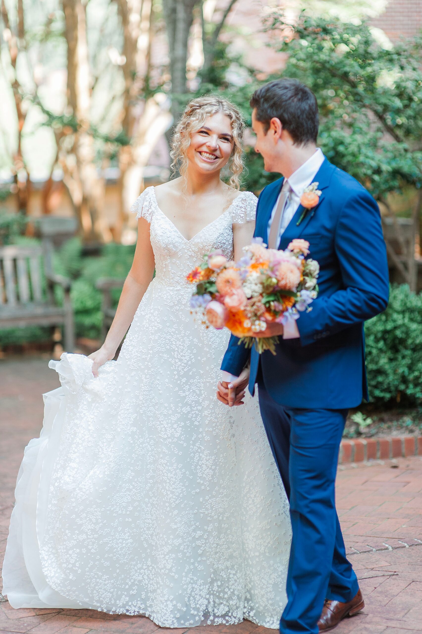 bride and groom walk together outside