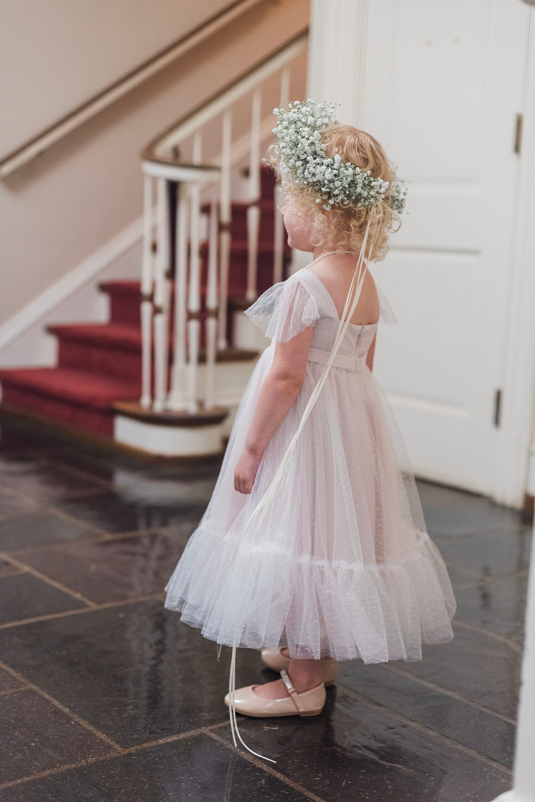 flower girl waits to walk down the aisle  