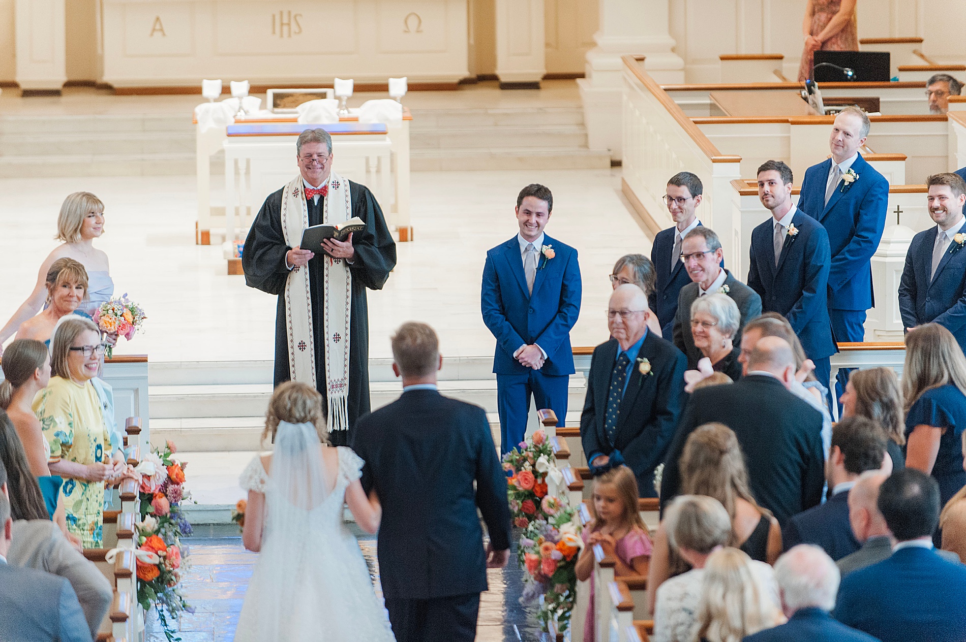 bride walks down aisle toward groom