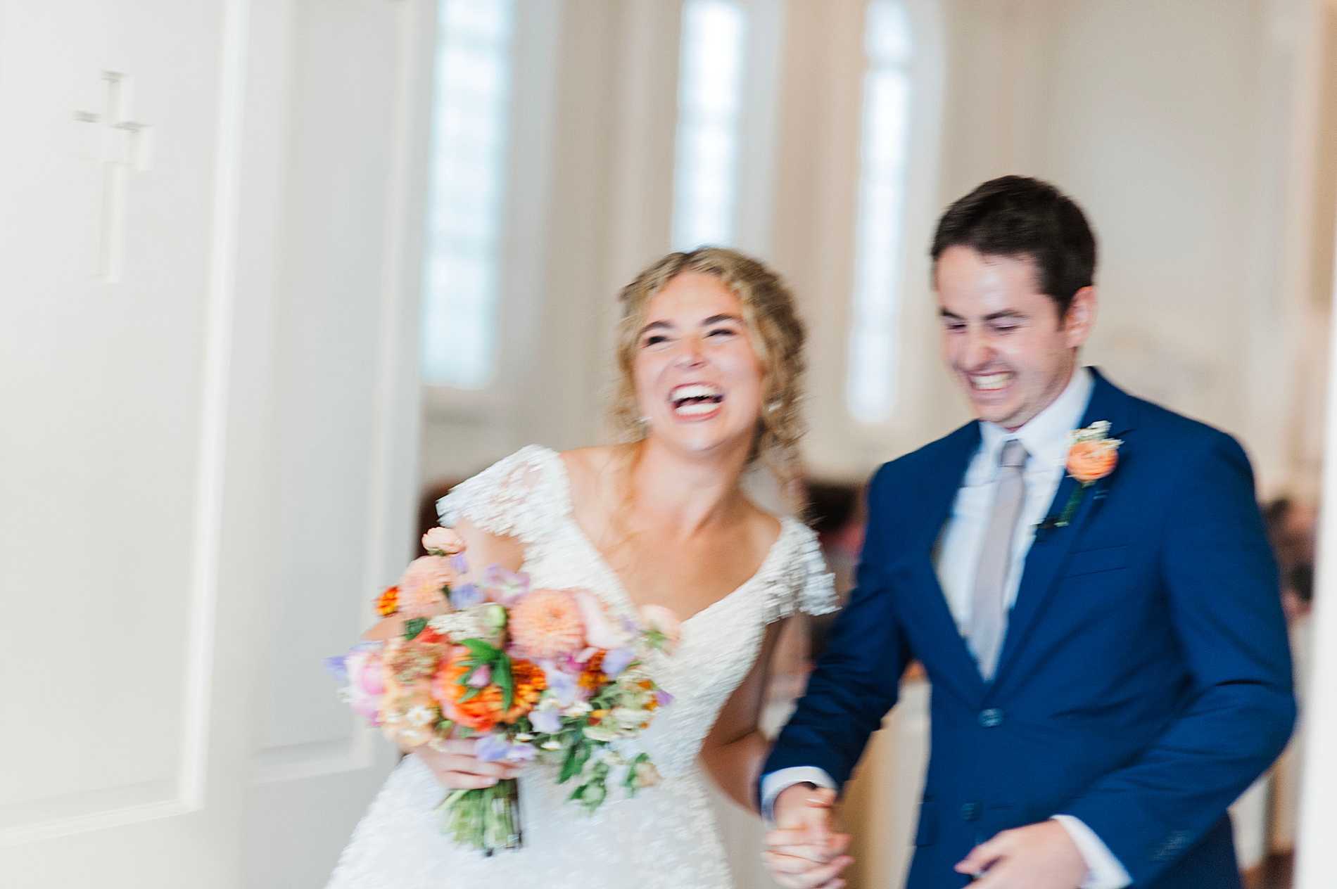 joyful and candid wedding photos of couple exiting church