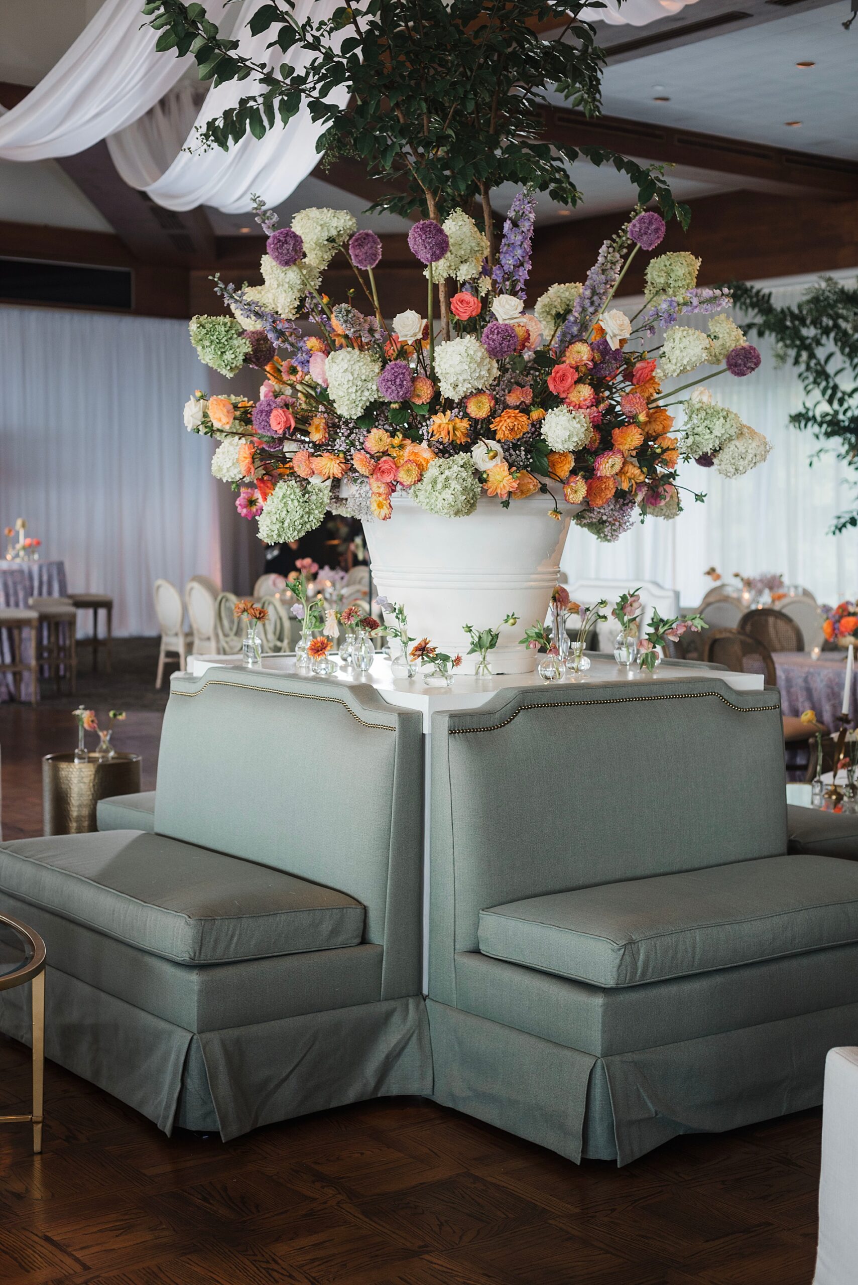 enchanting floral display surrounded by sage green seating