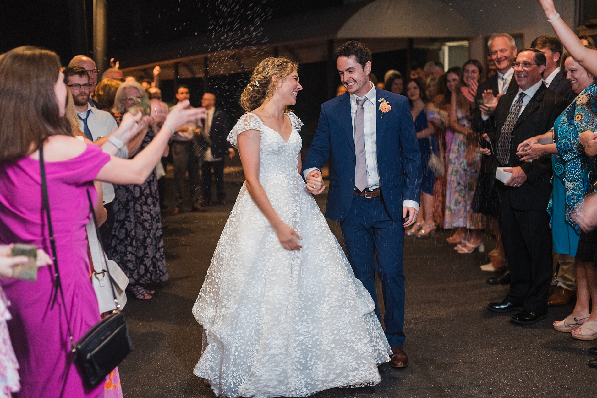 newlyweds exit wedding reception