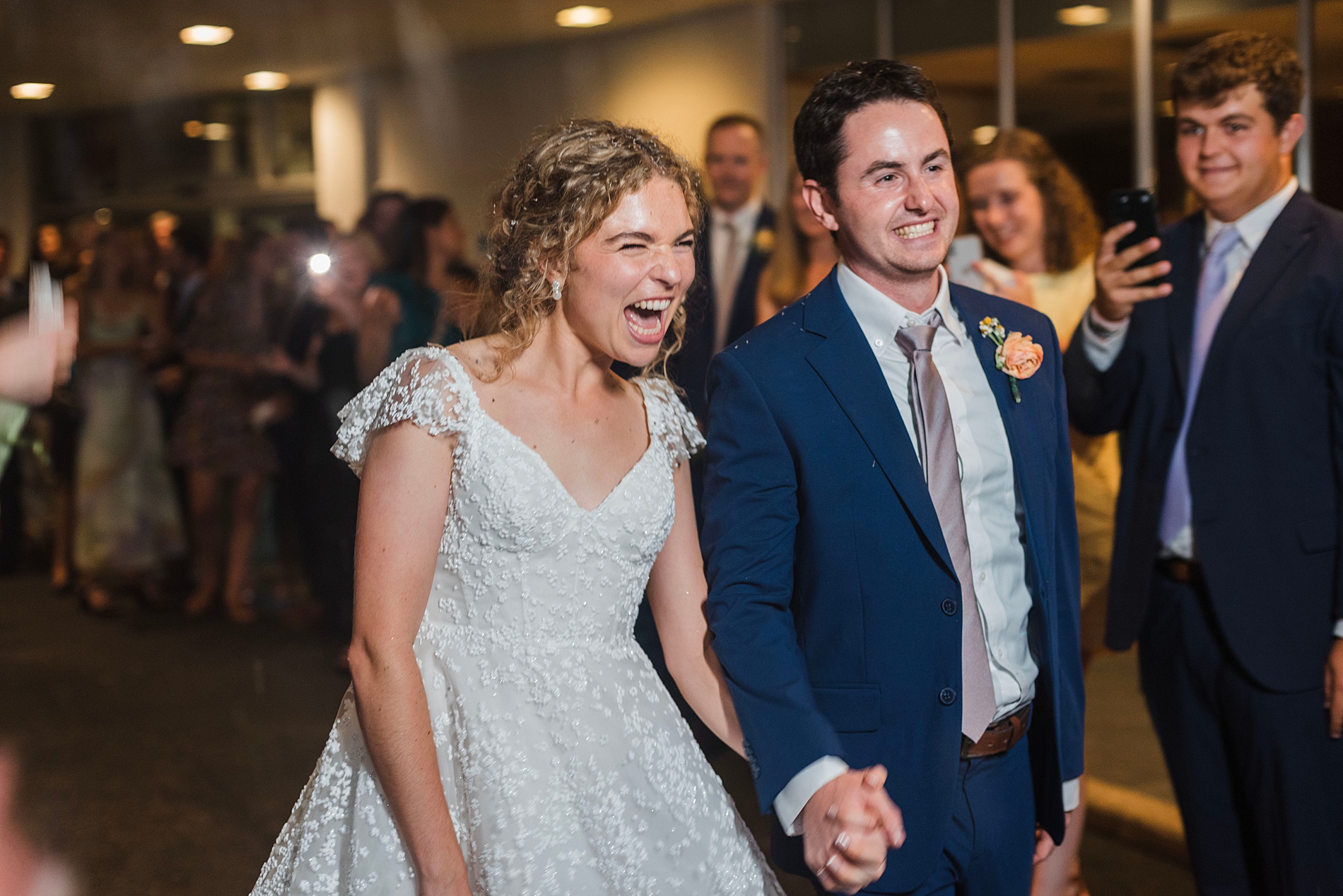 candid and joyful wedding photos of newlyweds exiting reception