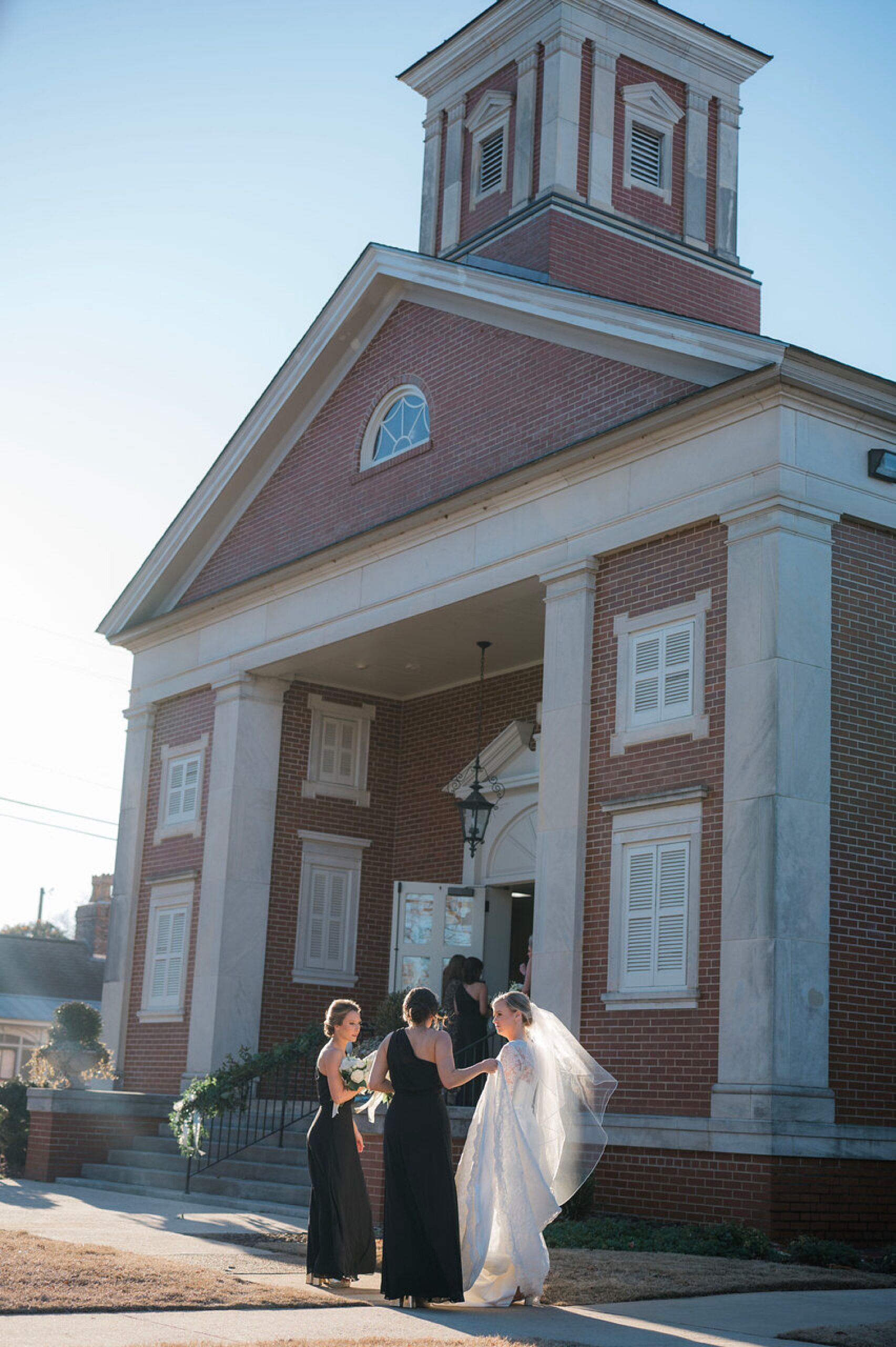 bride and bridesmaids outside of church