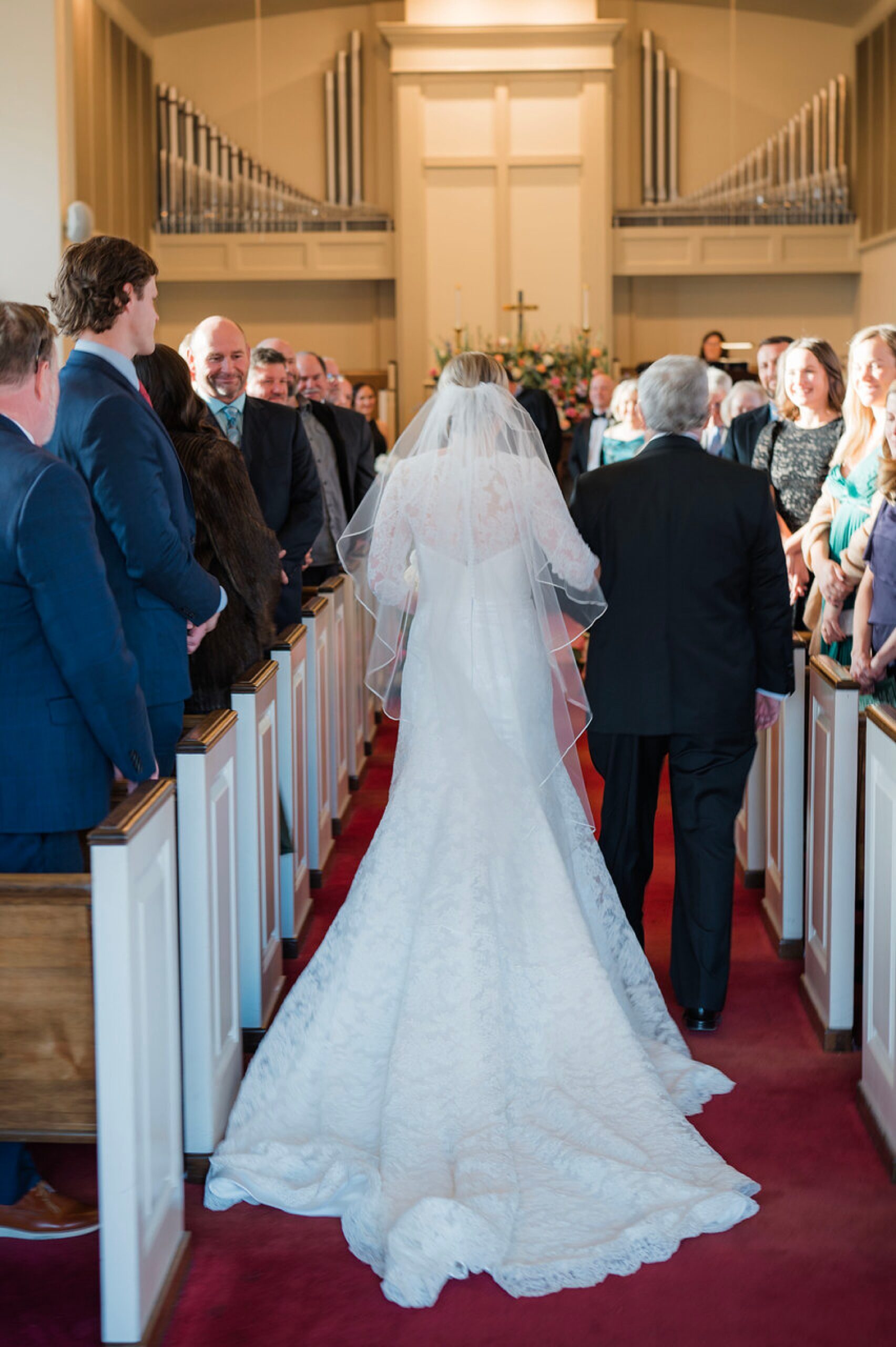 bride walks down the aisle with father