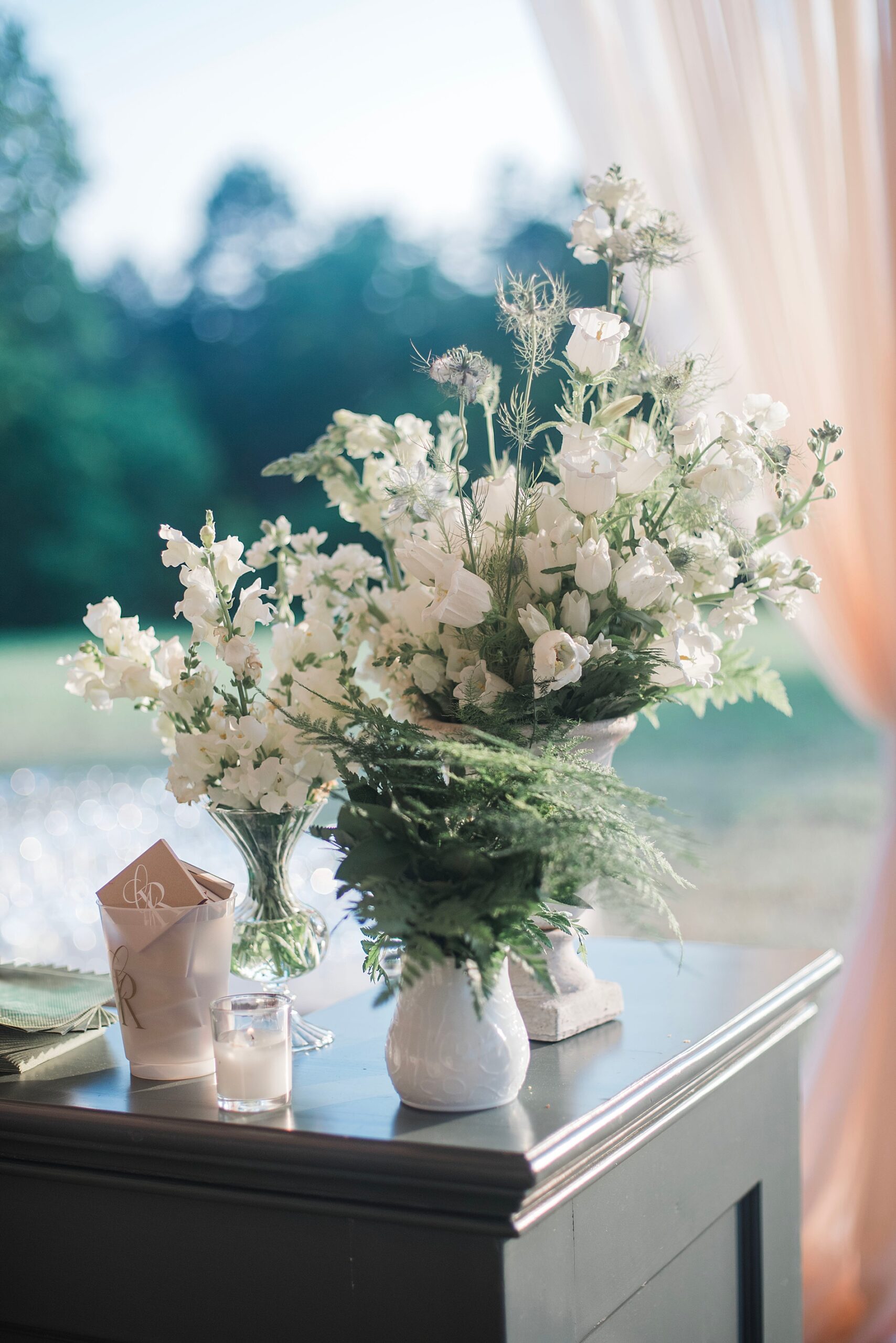 fresh white flowers and greenery in vases