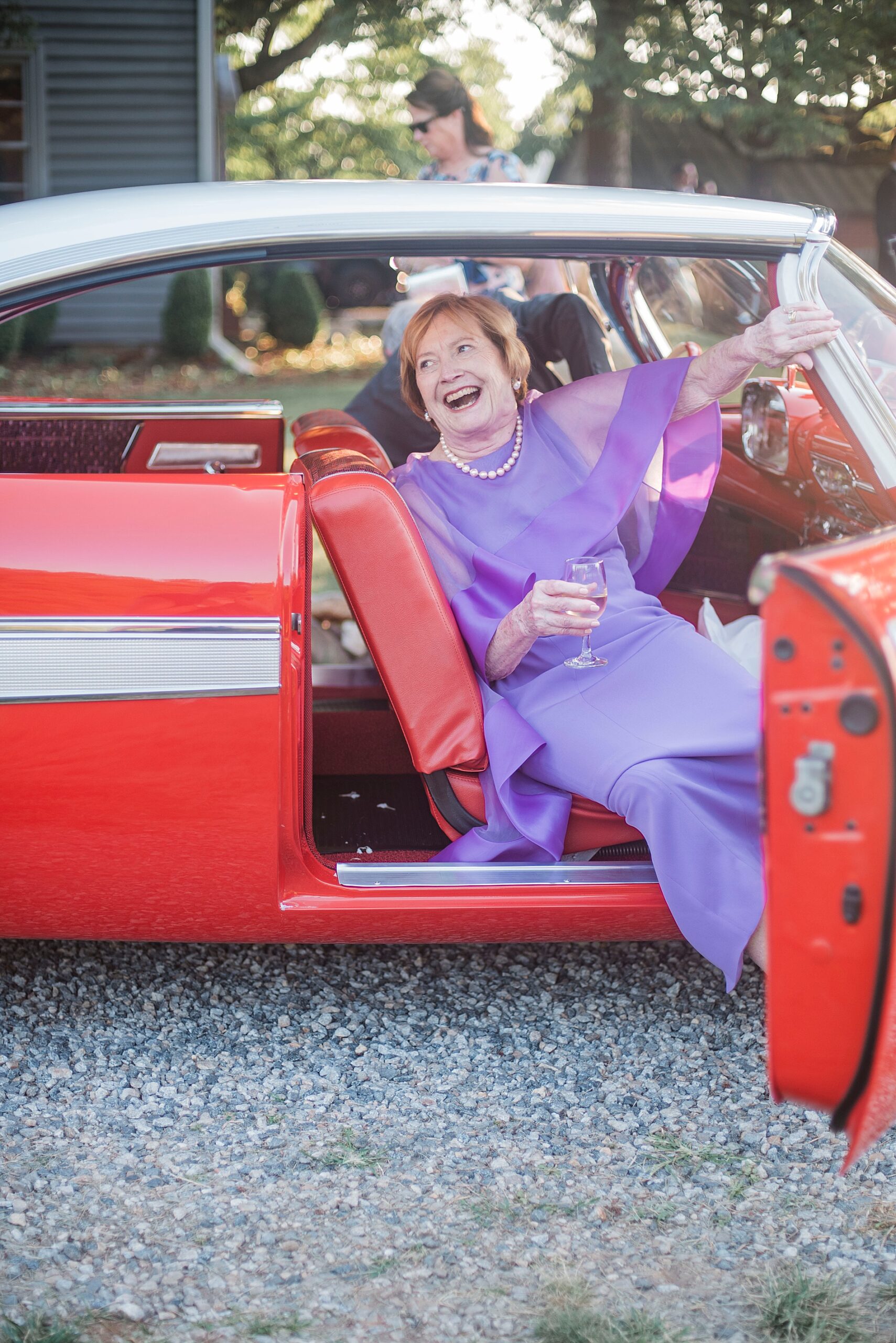 bride's grandmother gets out of red car from Heartfelt North Carolina Wedding