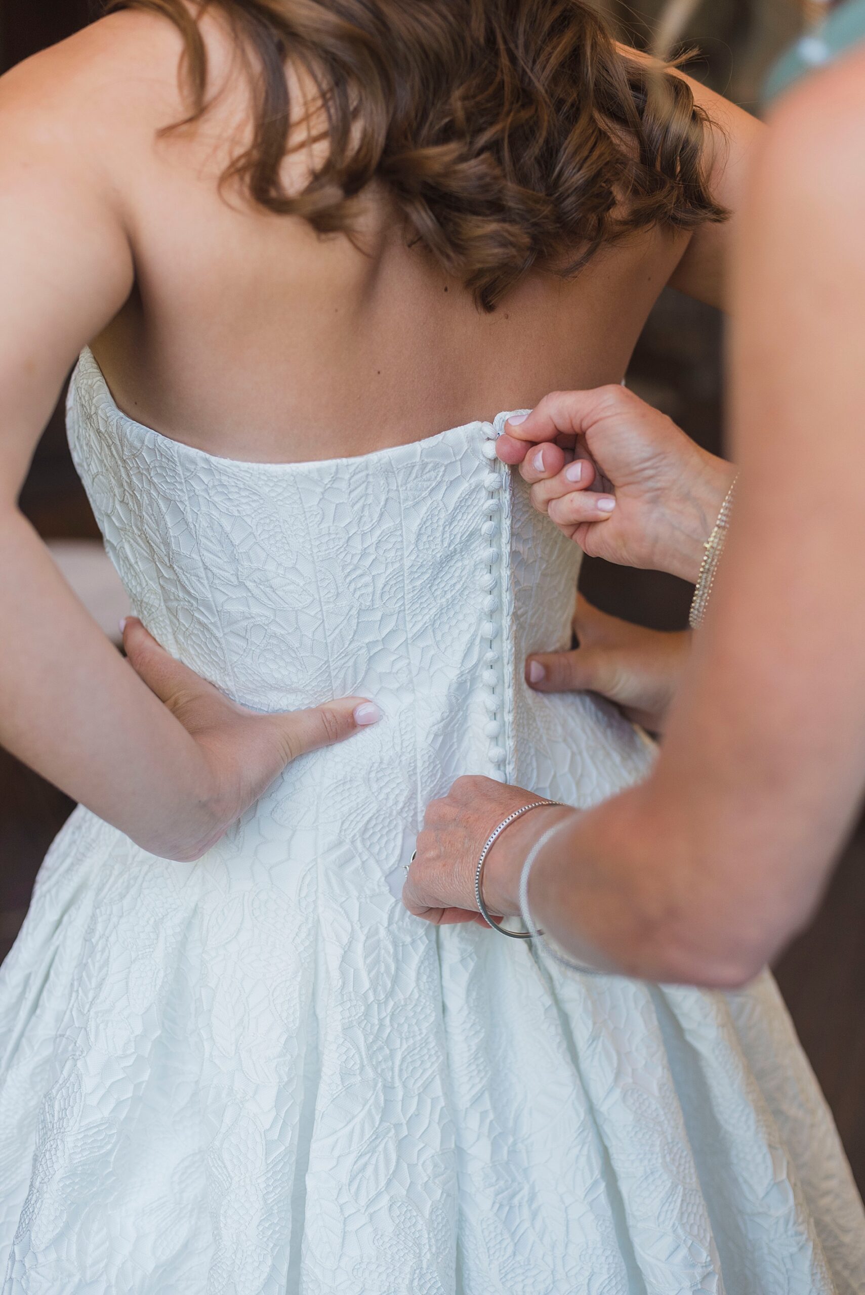 bride gets into wedding dress