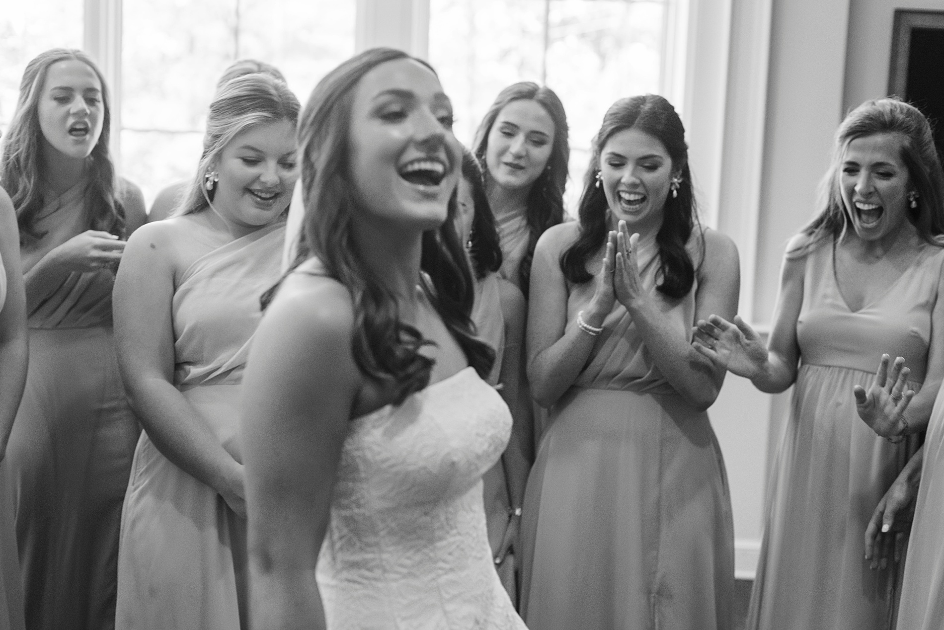 bridesmaids see bride in wedding dress for first time