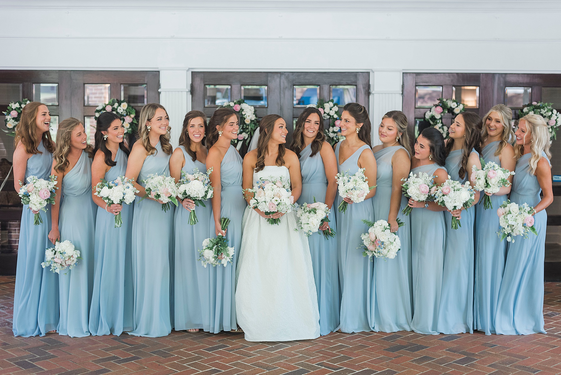 bride with bridesmaids in dusty blue dresses