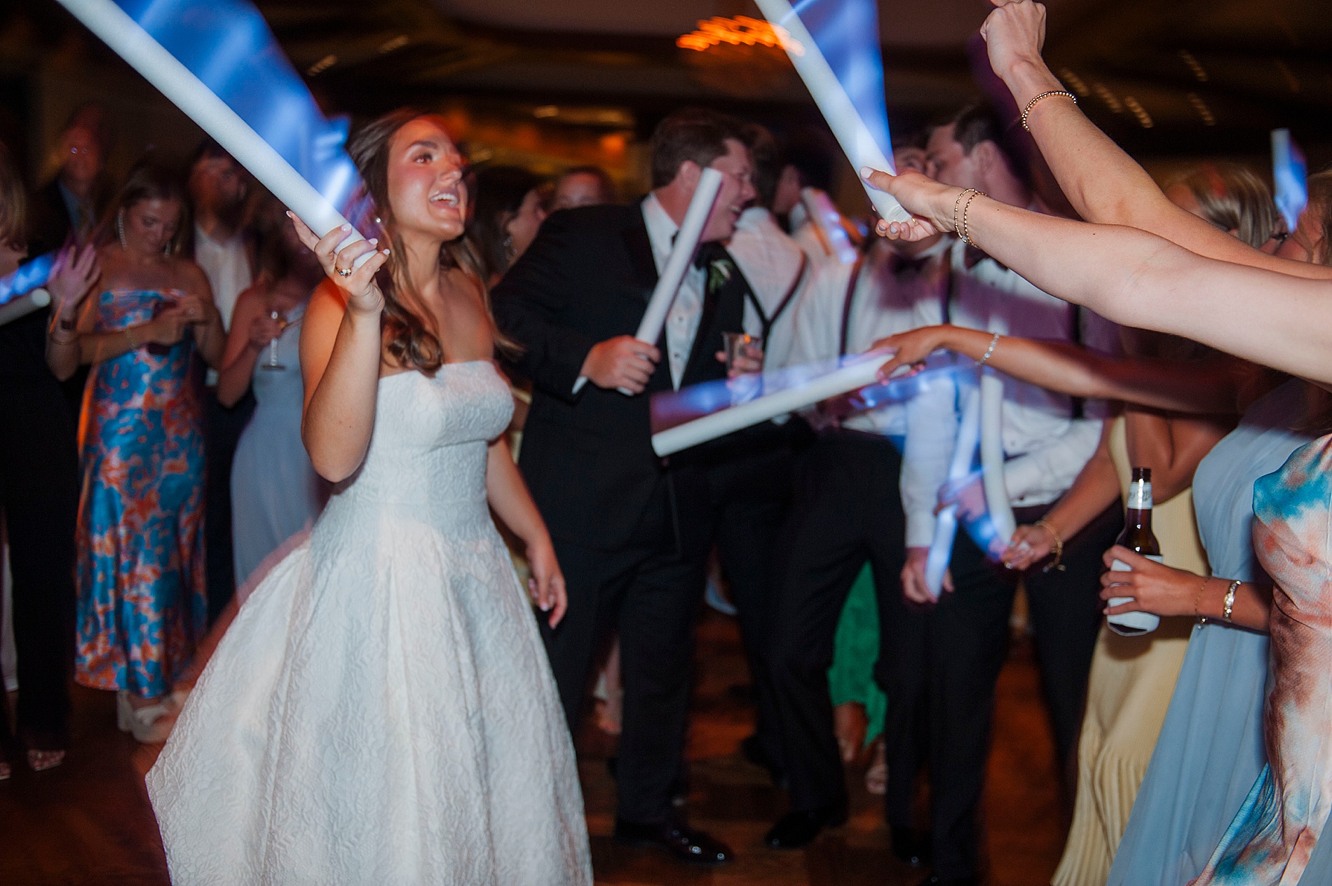 bride and guests dance with glowsticks