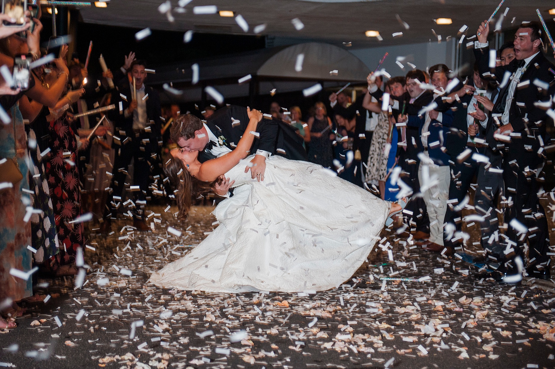 Memorable Birmingham Wedding exit with confetti as bride and groom kiss