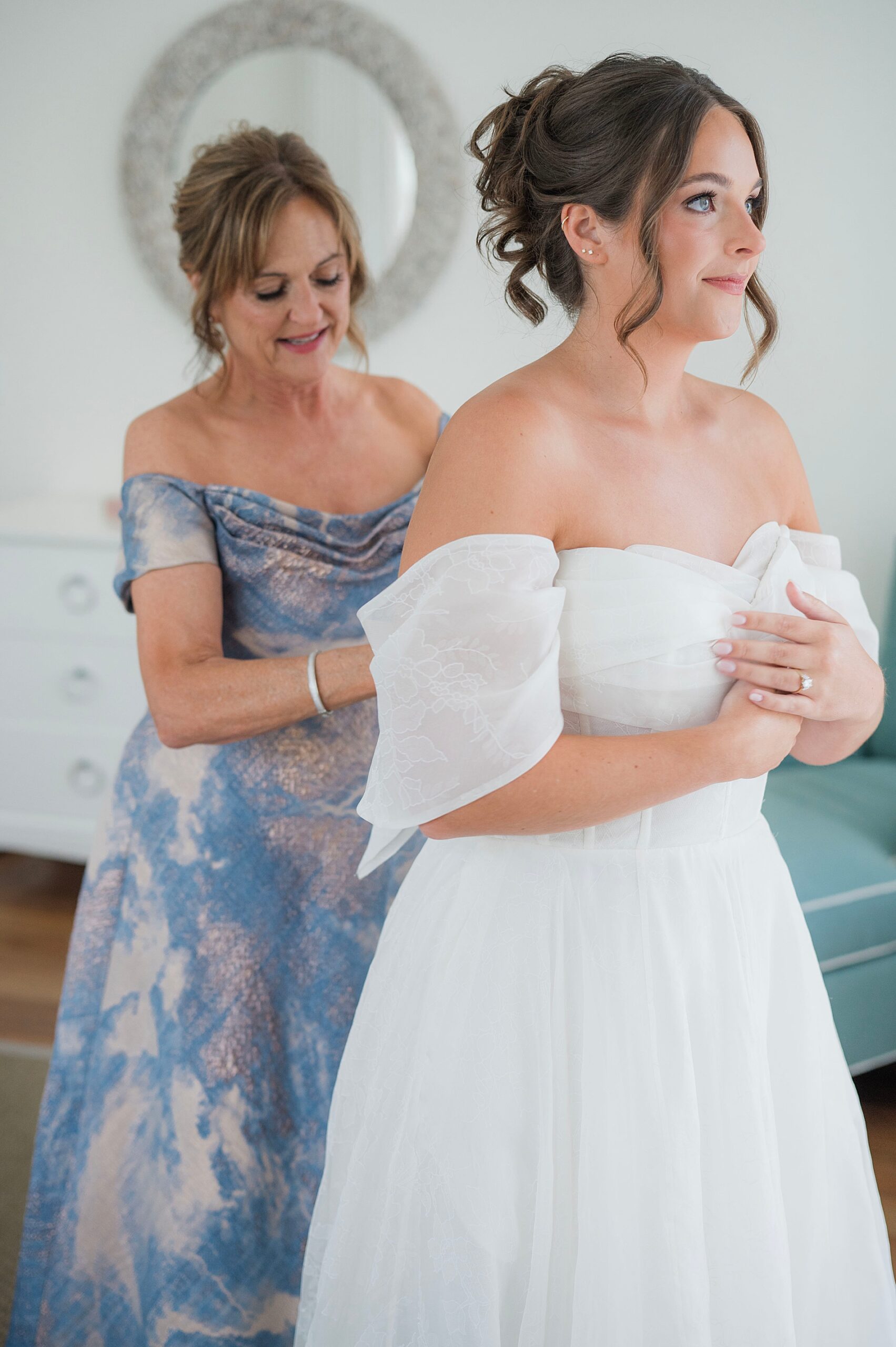 bride getting into wedding dress