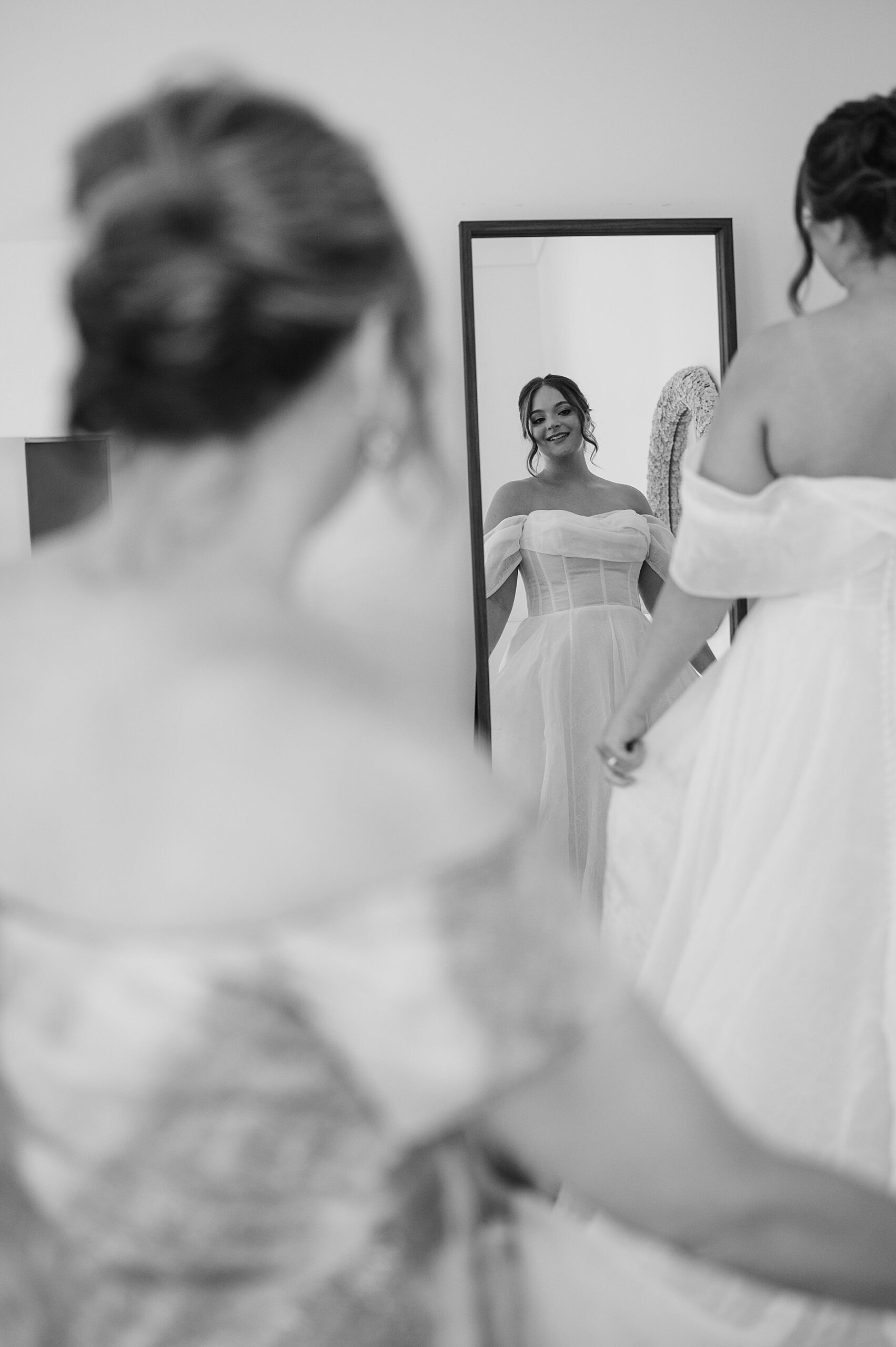 bride looks at herself in mirror