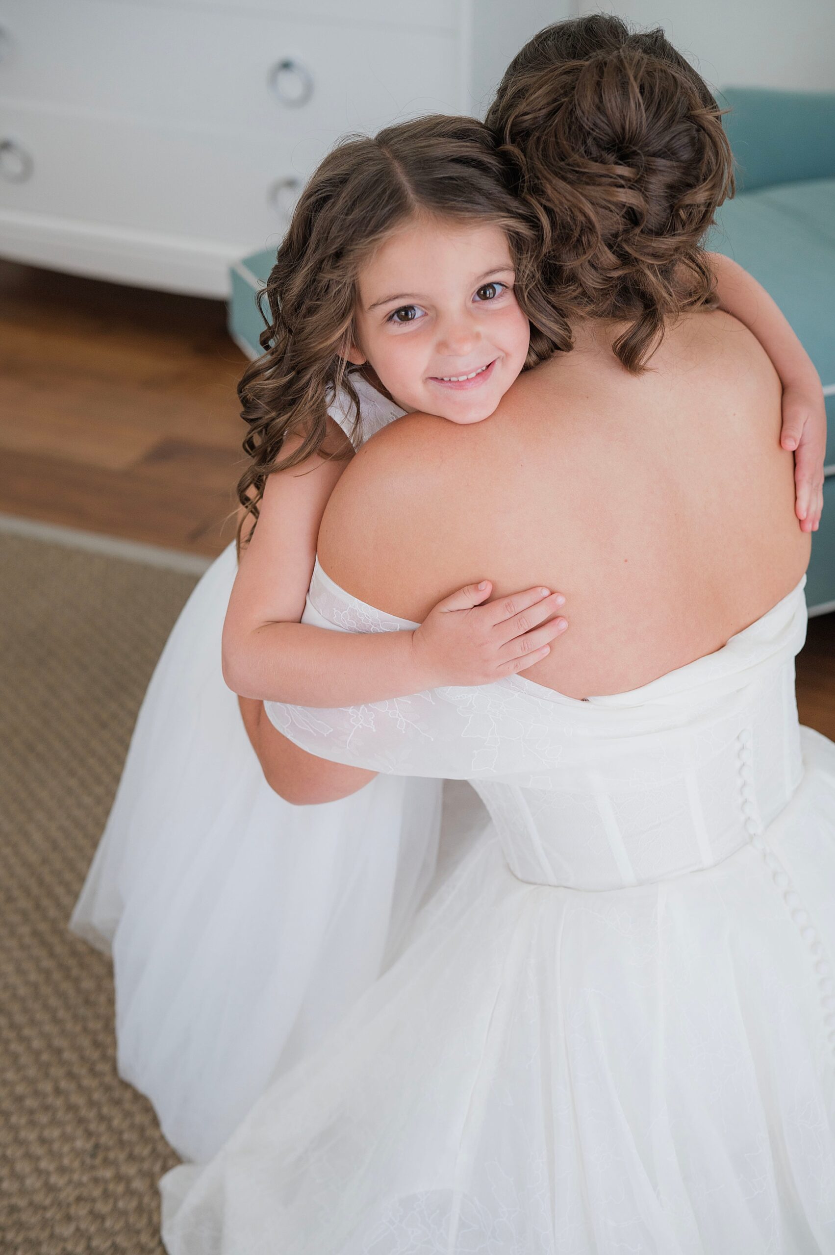 flower girl hugs bride