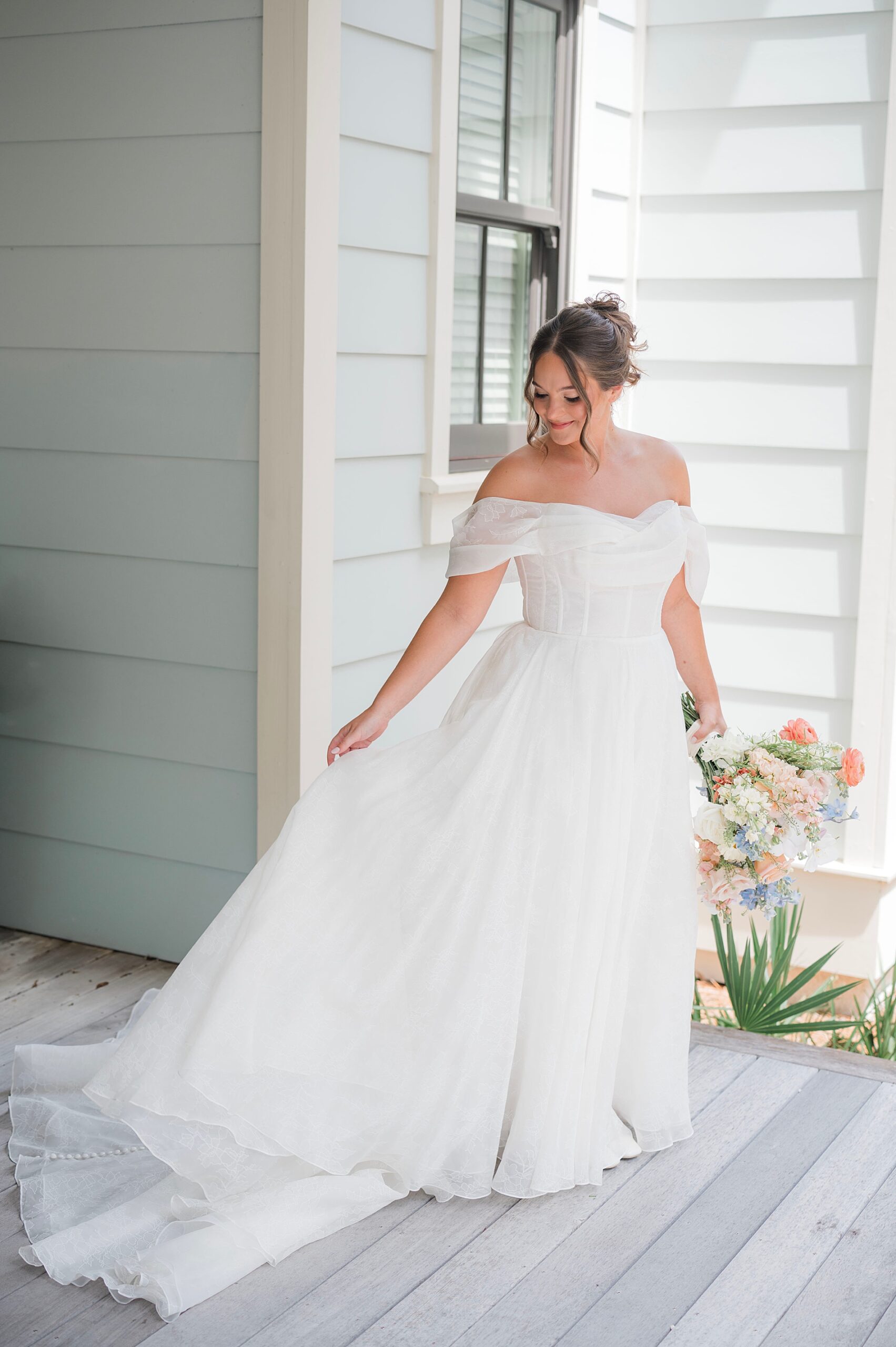 bride shows off wedding dress from Coastal Florida Wedding