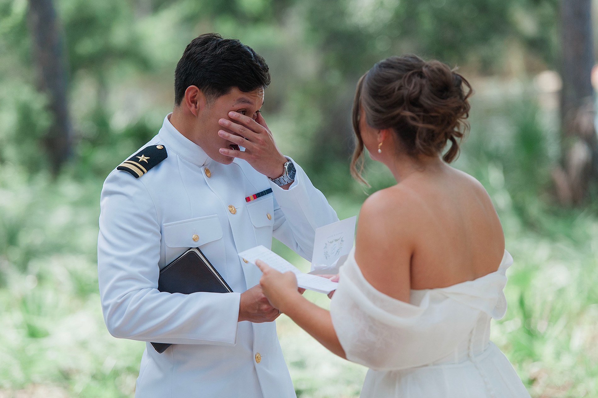groom wipes away tears during first look and vow exchange