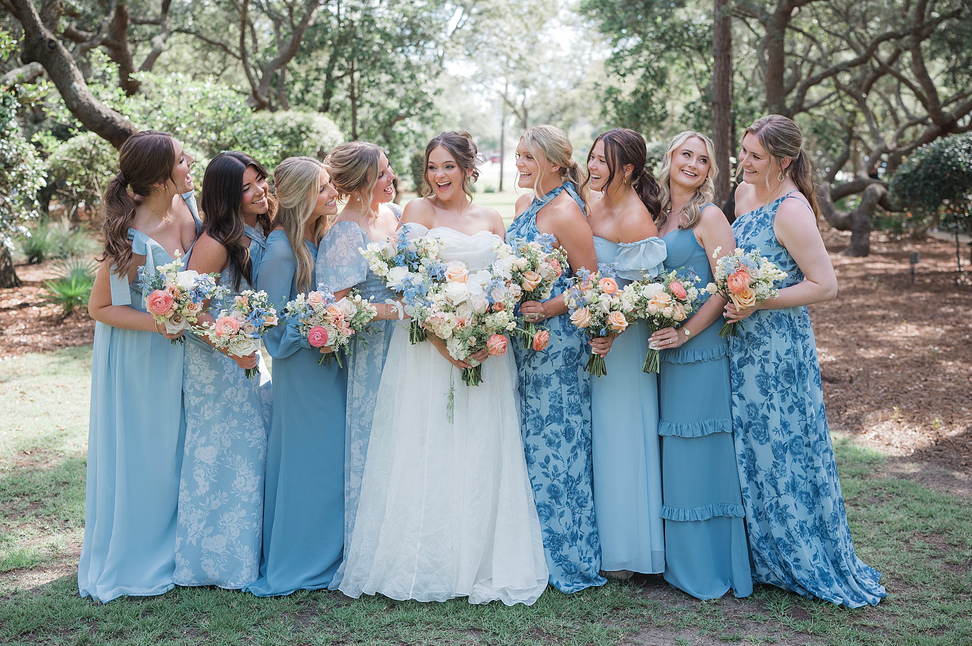 bridesmaids in blue dresses look to bride