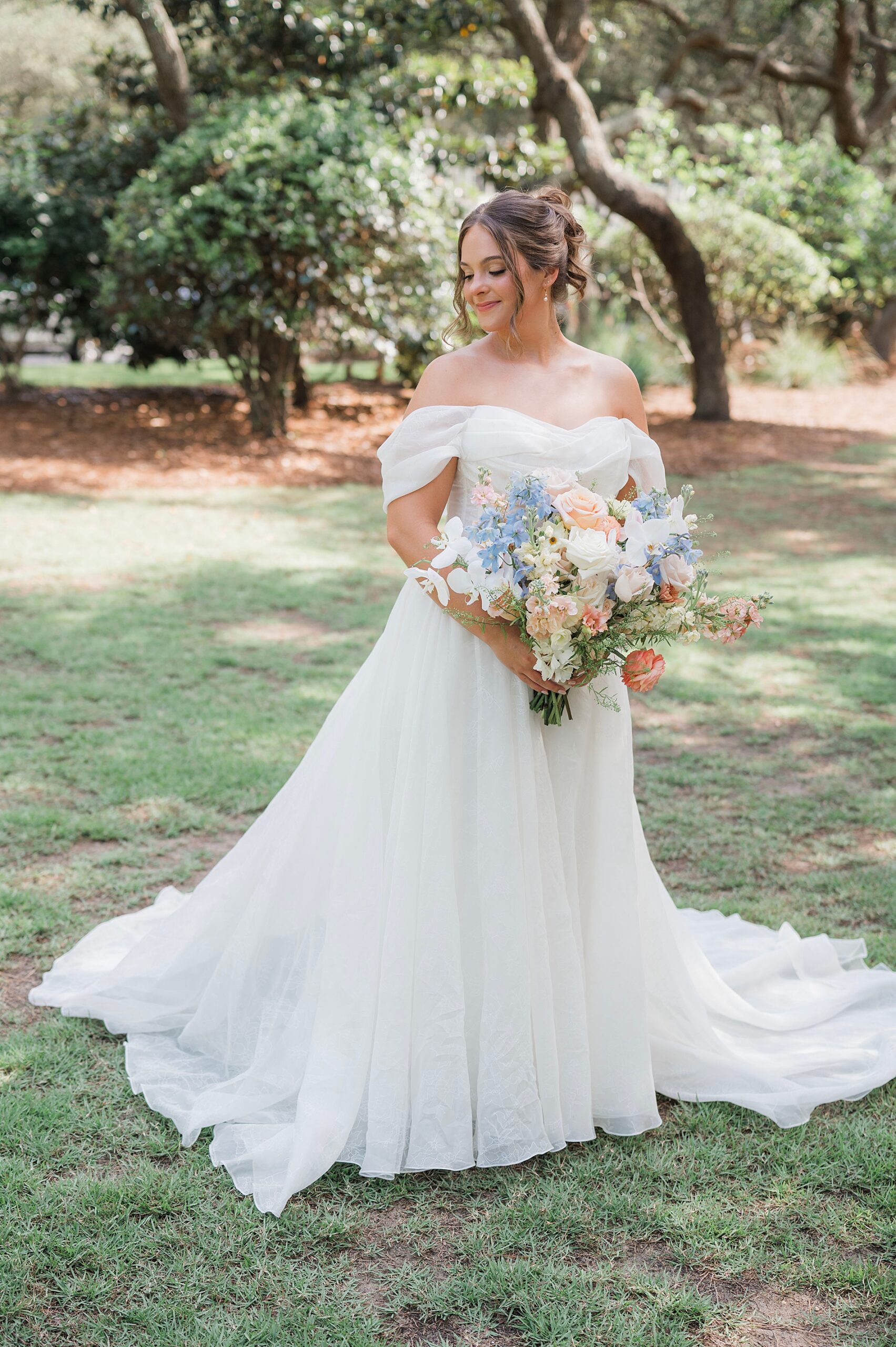 bride holds bouquet of soft florals