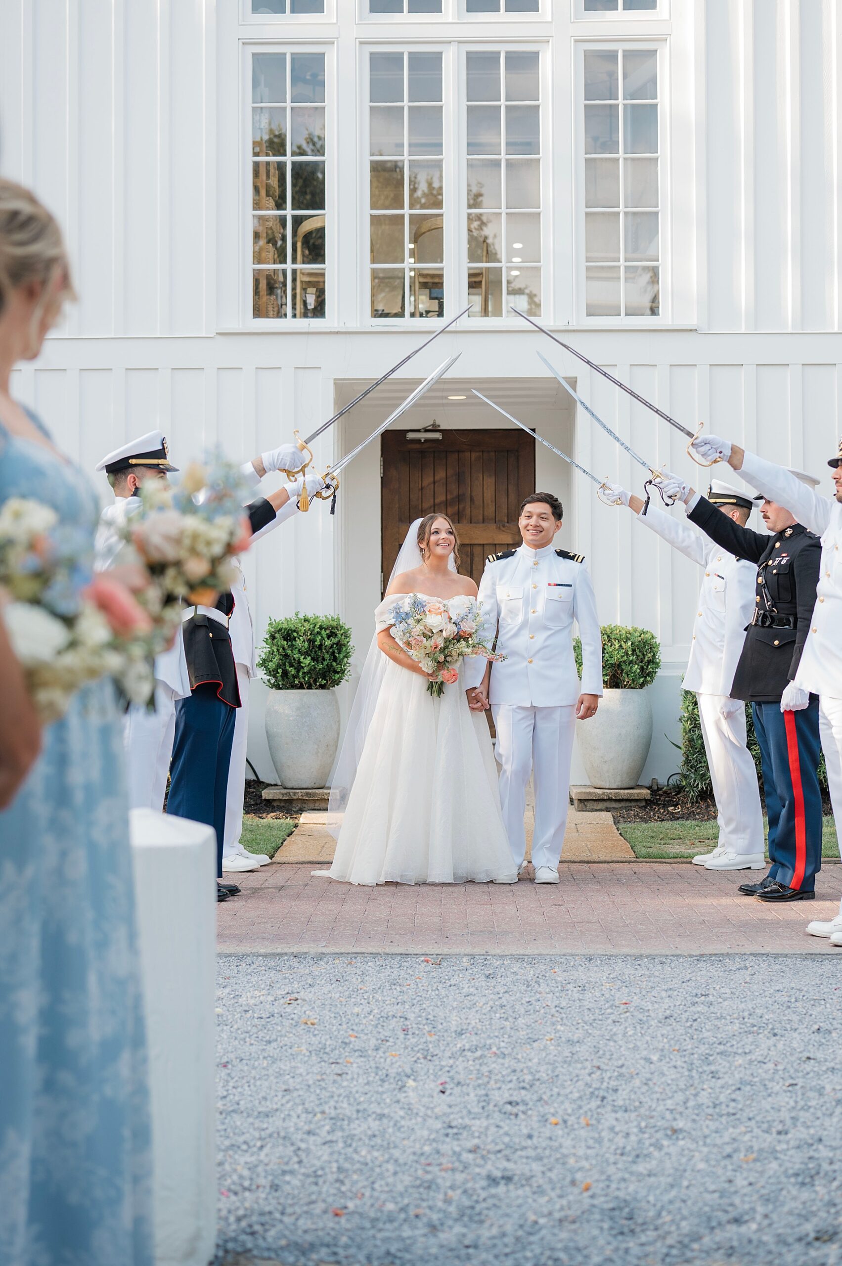 bride and groom exit church for naval sword ceremony