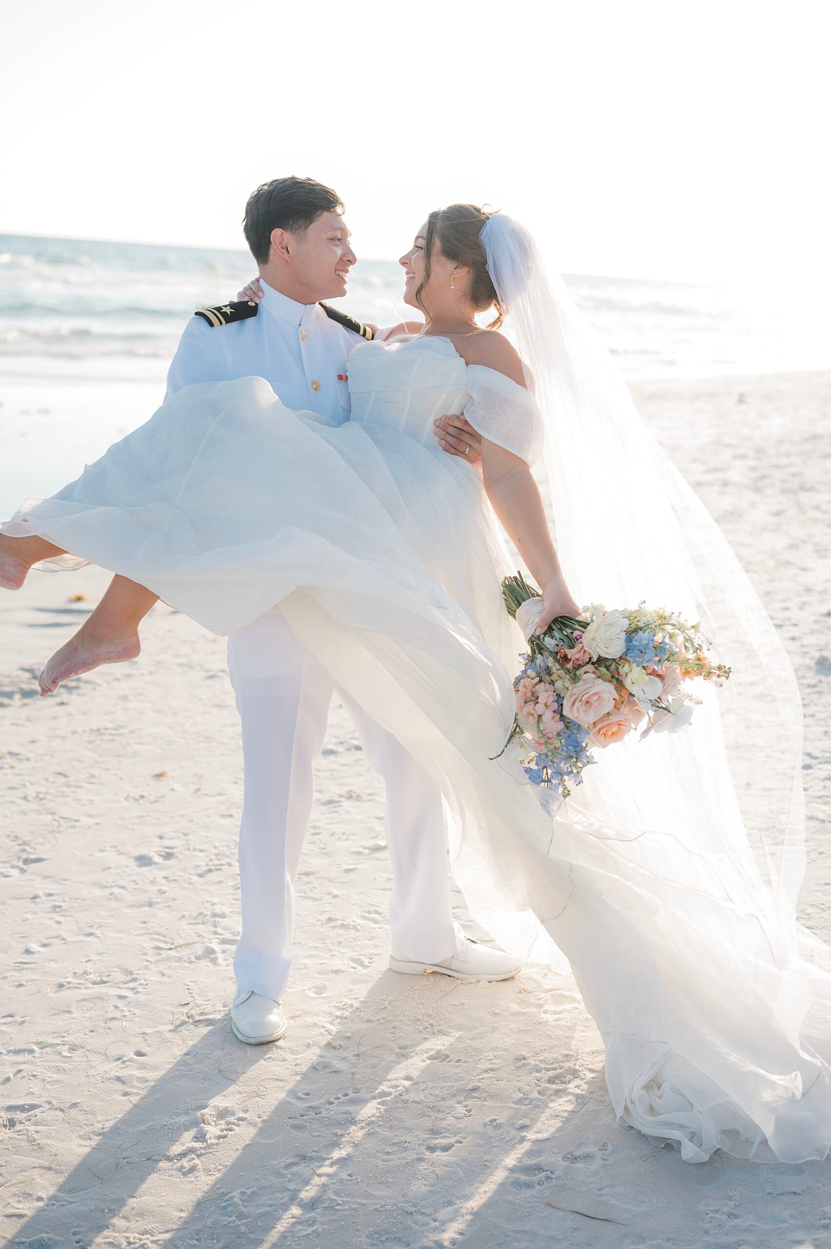 groom picks up and carries bride in arms
