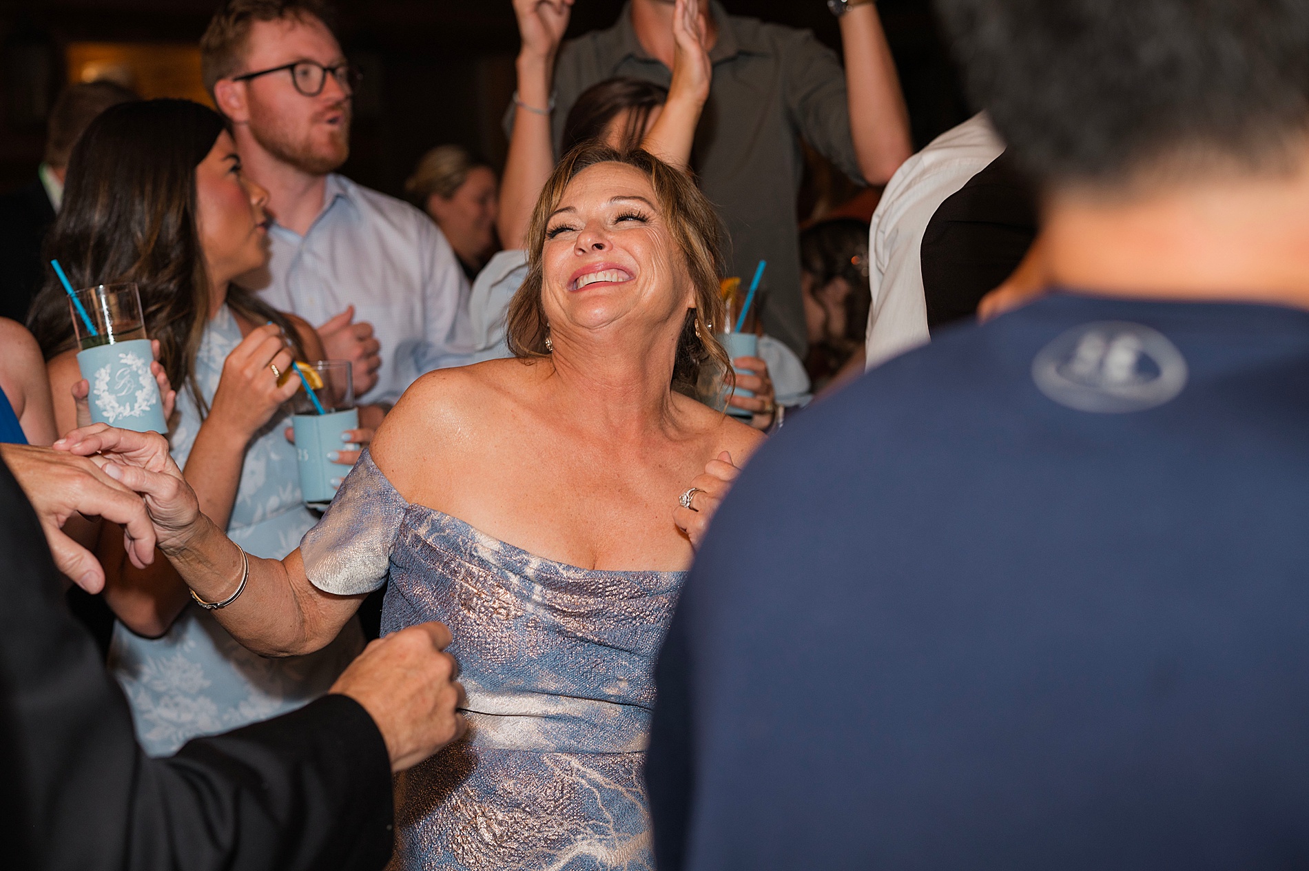 candid photos from wedding reception of guests dancing