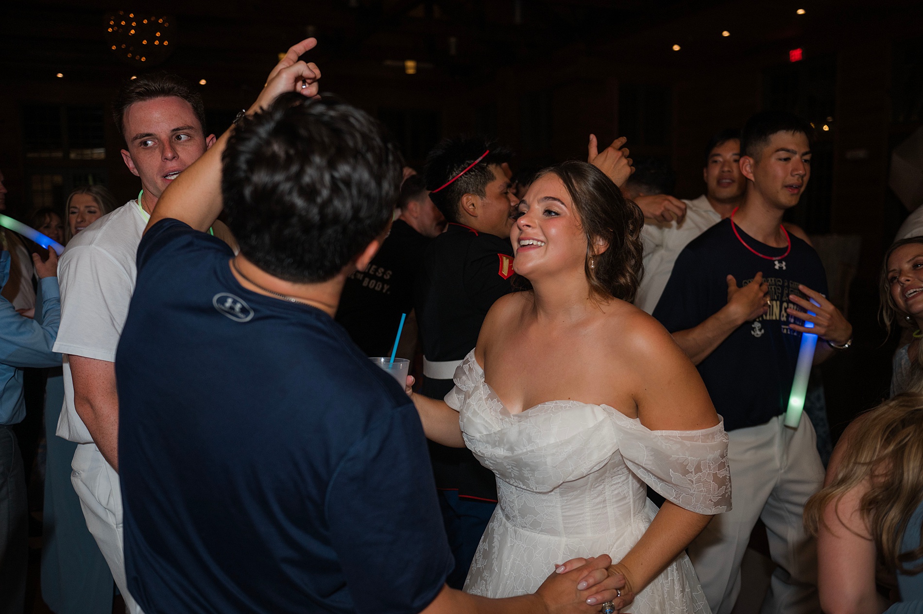 newlyweds on dance floor surrounded by guests