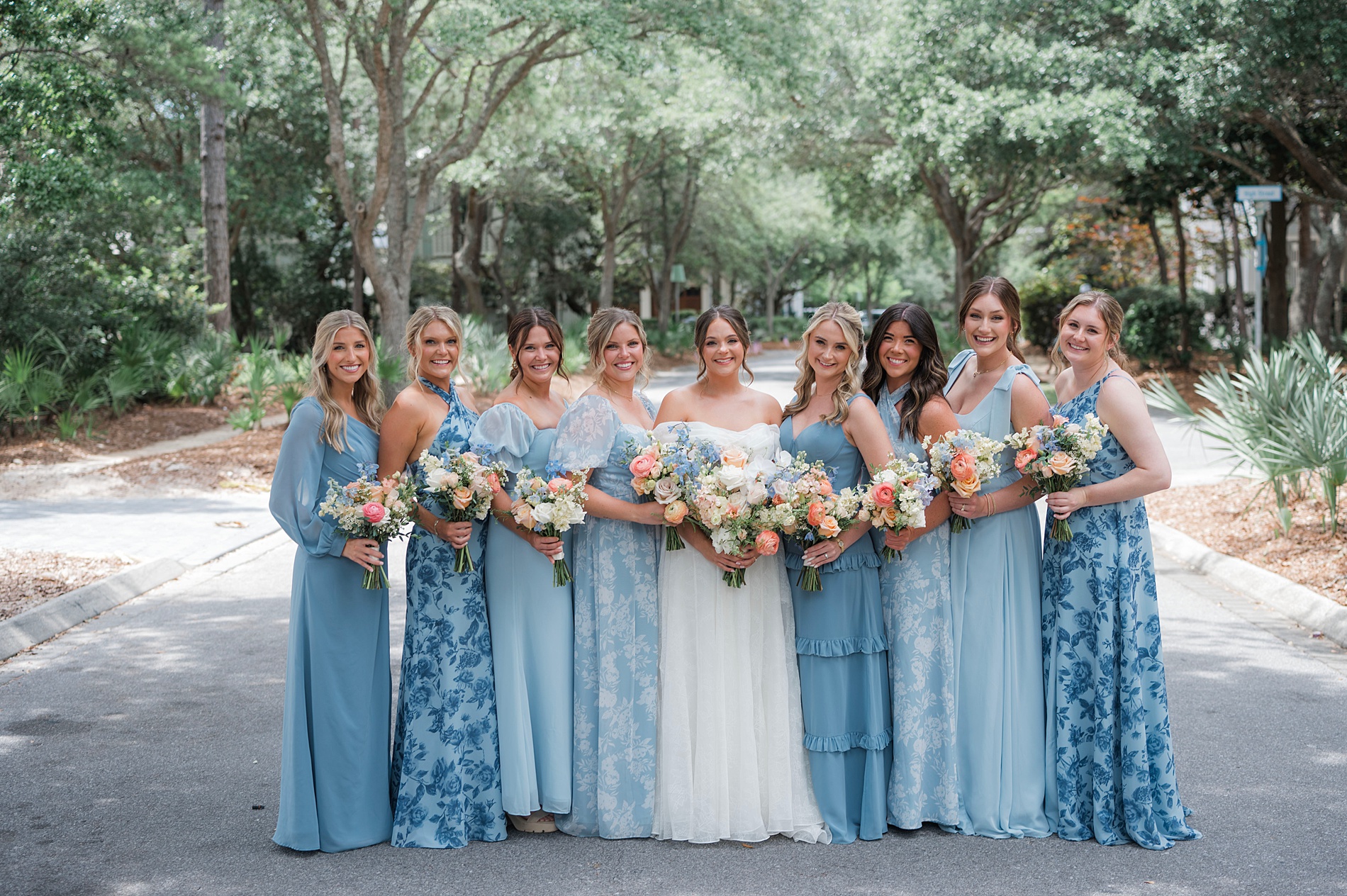 bride with bridesmaids in different blue dresses