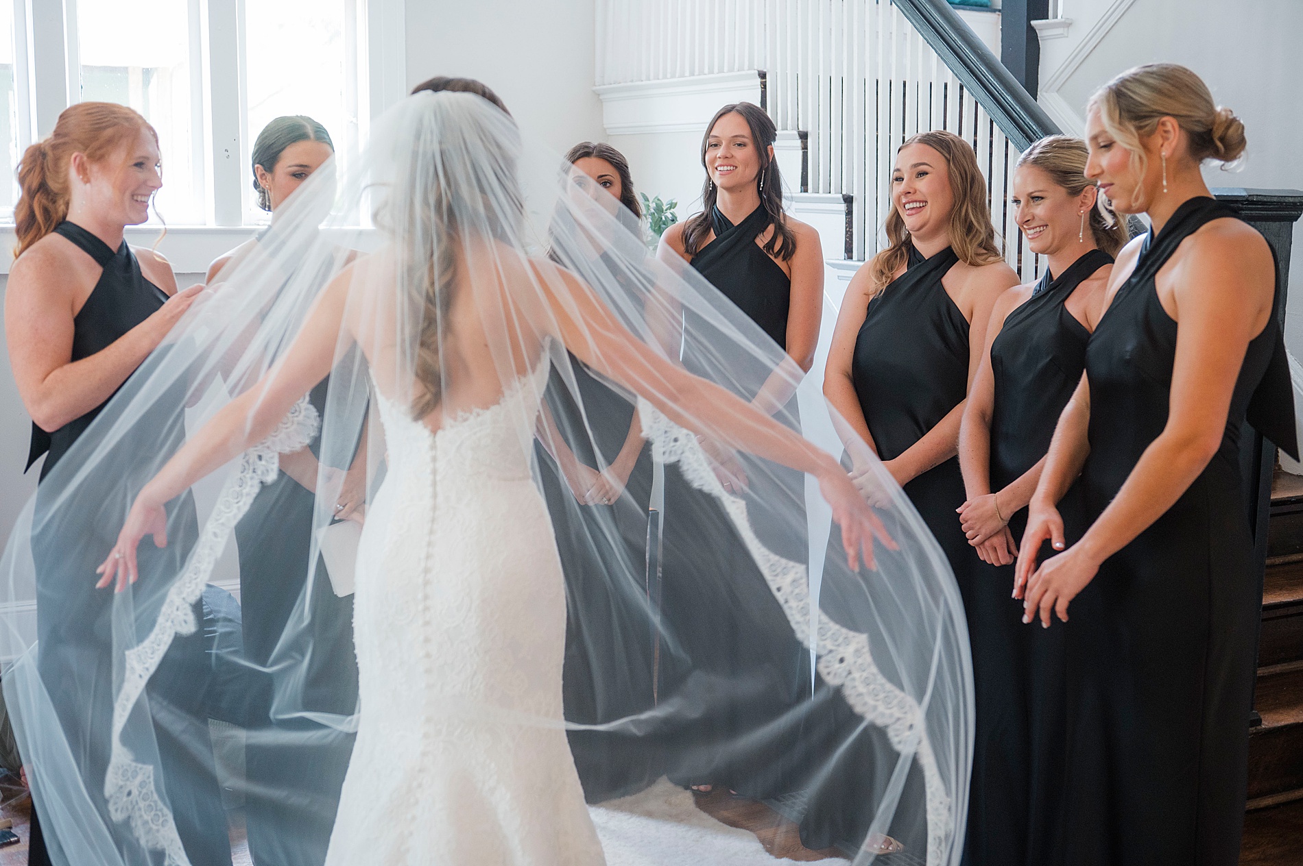 bride shows off wedding dress during bridesmaid first look