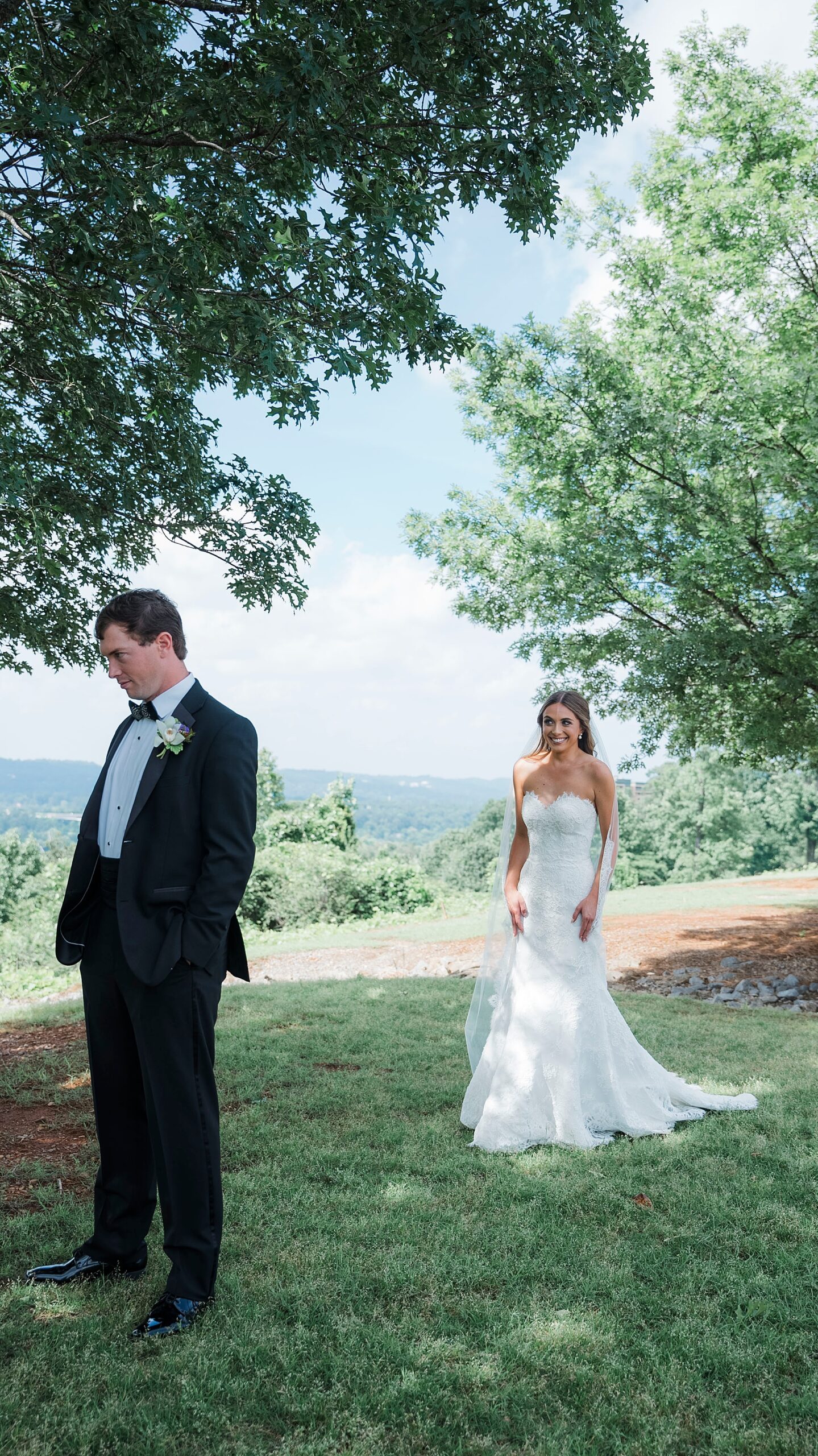 bride walks behind groom for first look