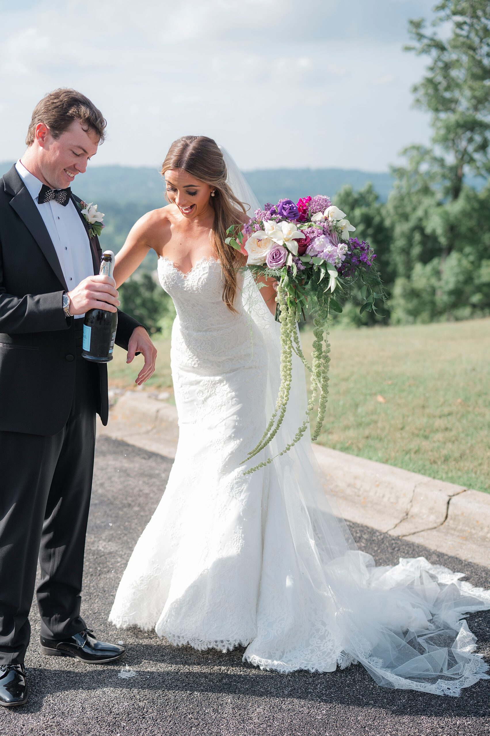 candid wedding photos of couple popping champagne
