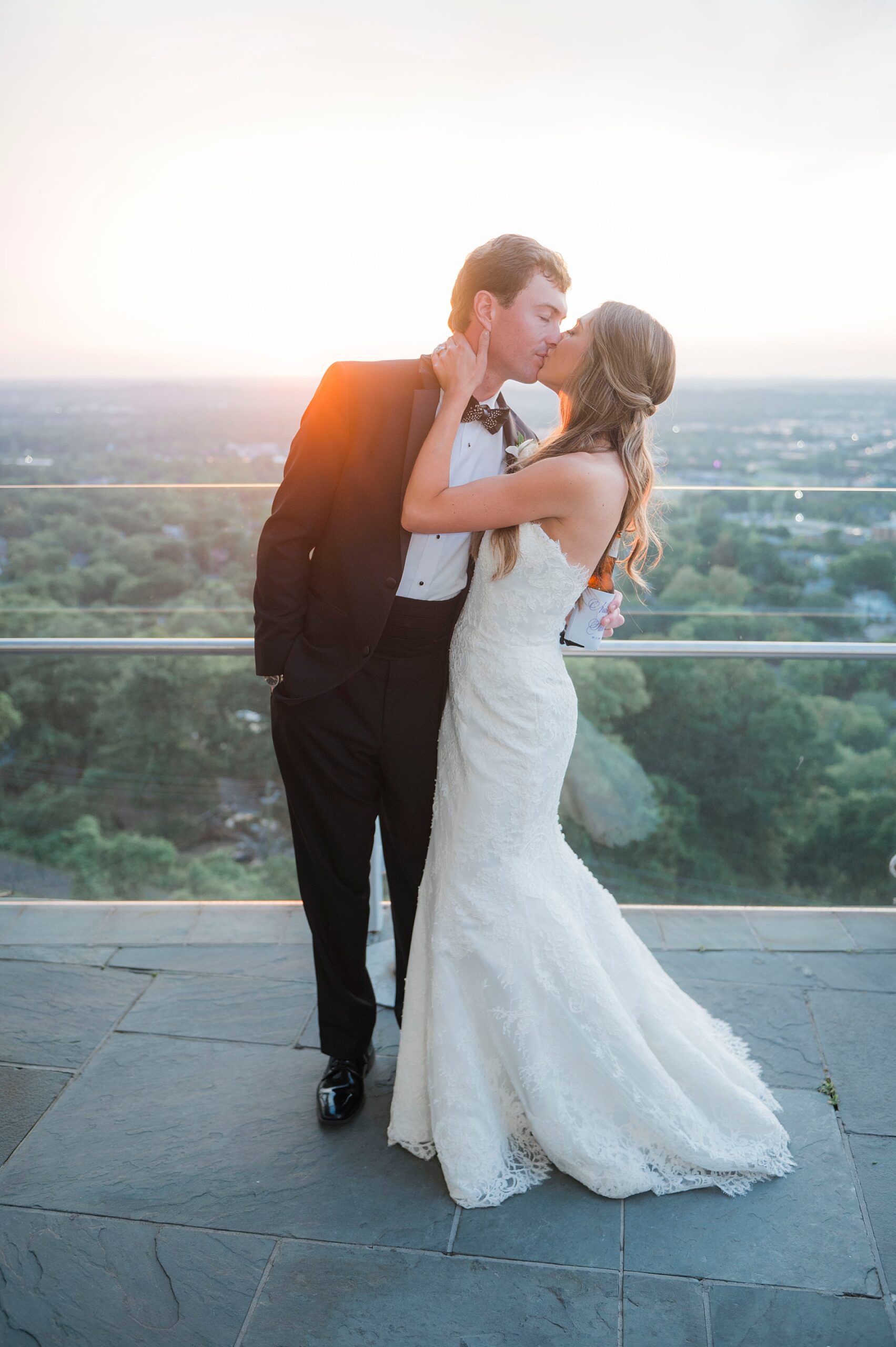 newlyweds kiss on balcony of wedding venue in Birmingham, AL