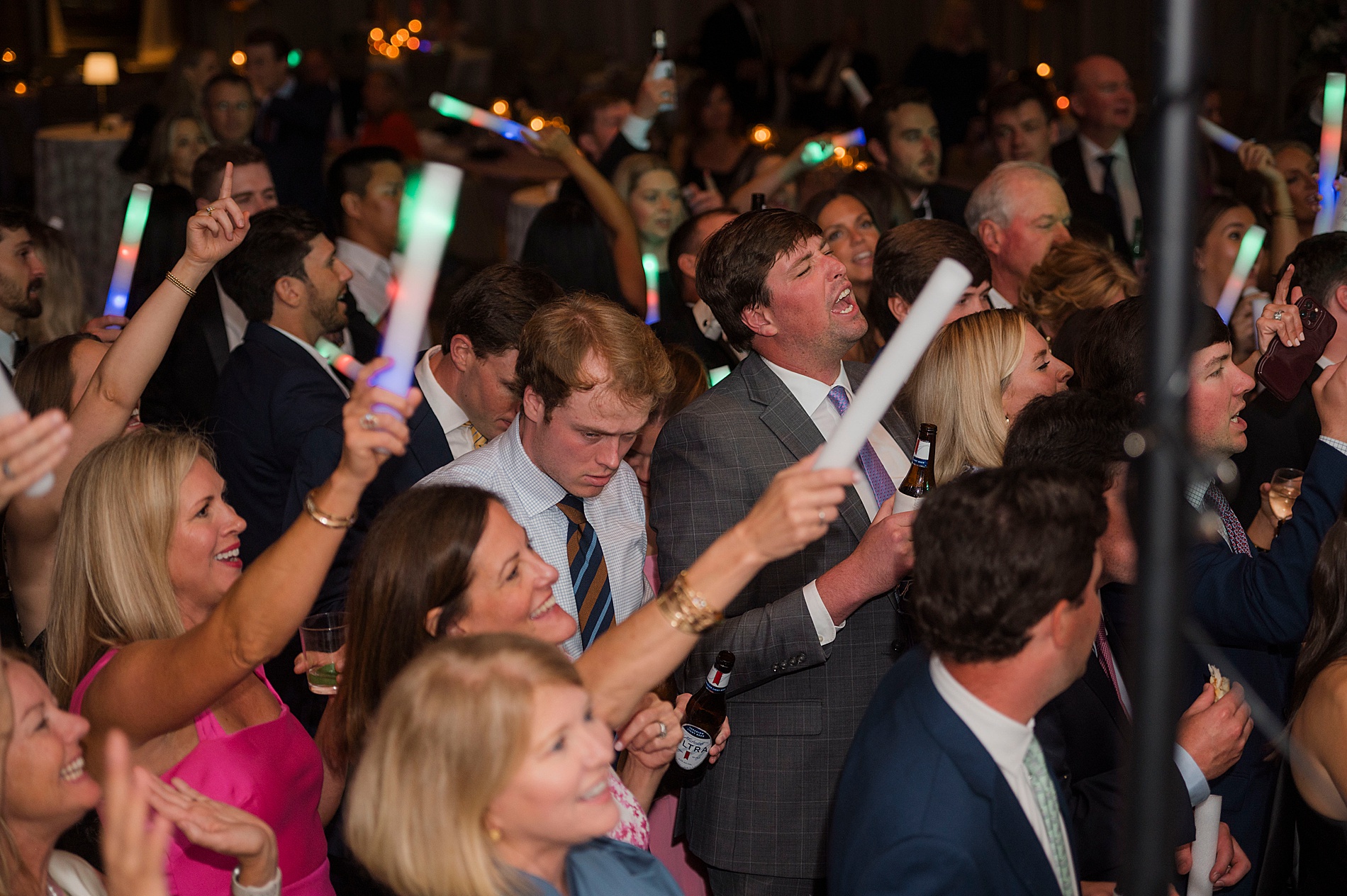 guests with glow sticks at wedding