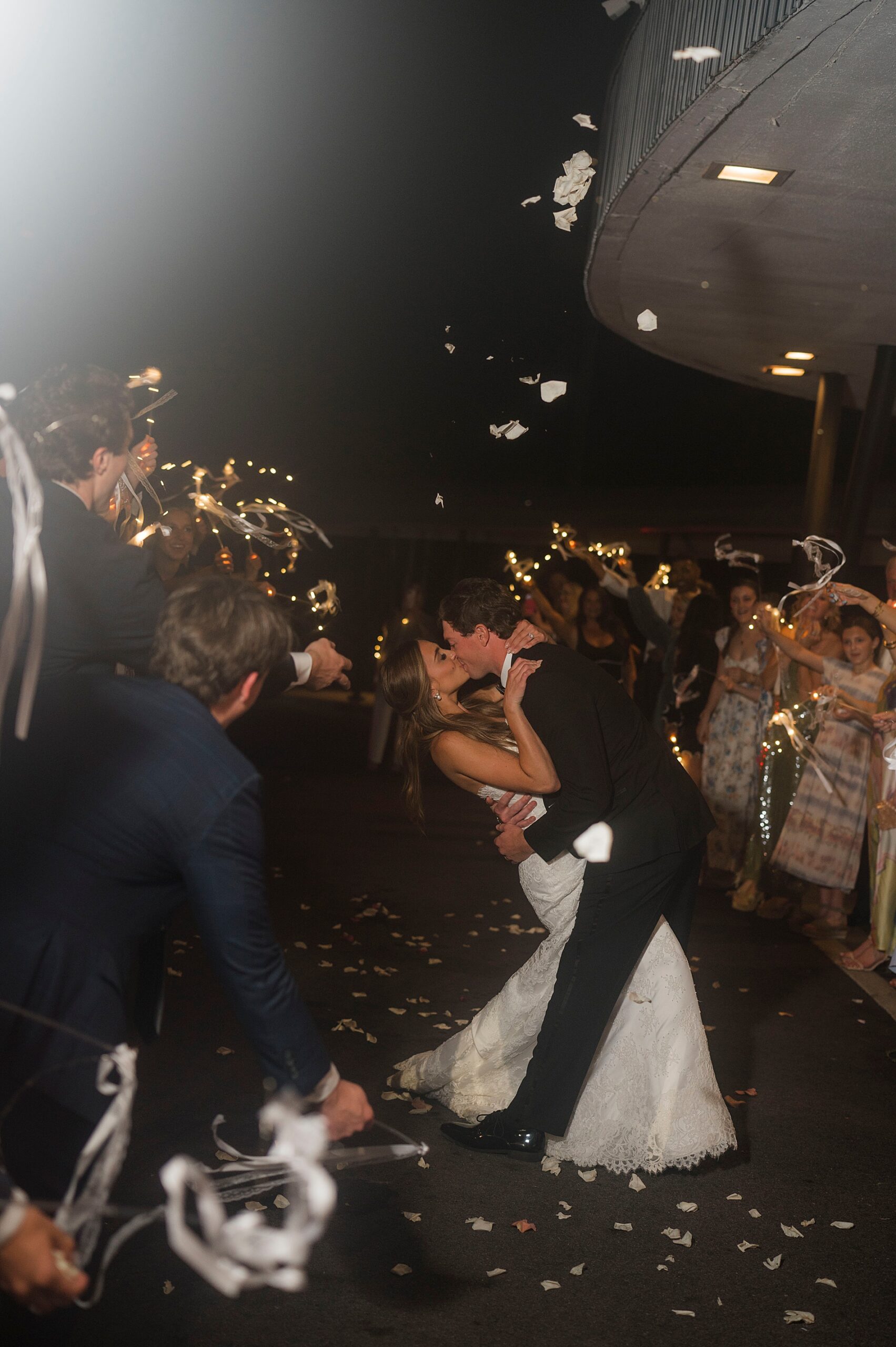 groom kisses bride during wedding exit