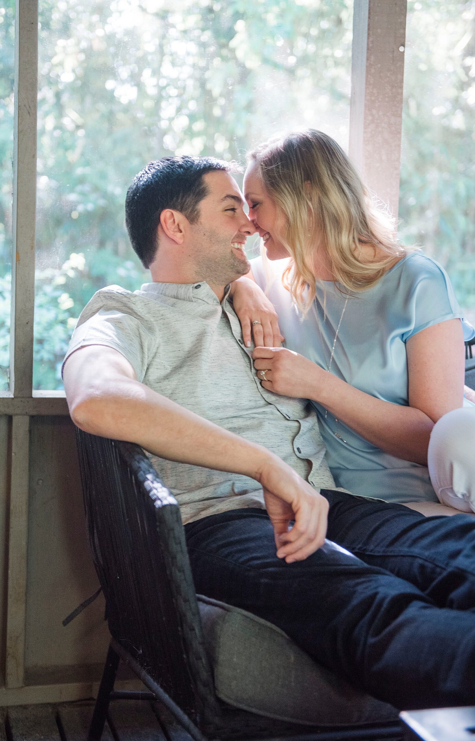 husband and wife sit together on couch