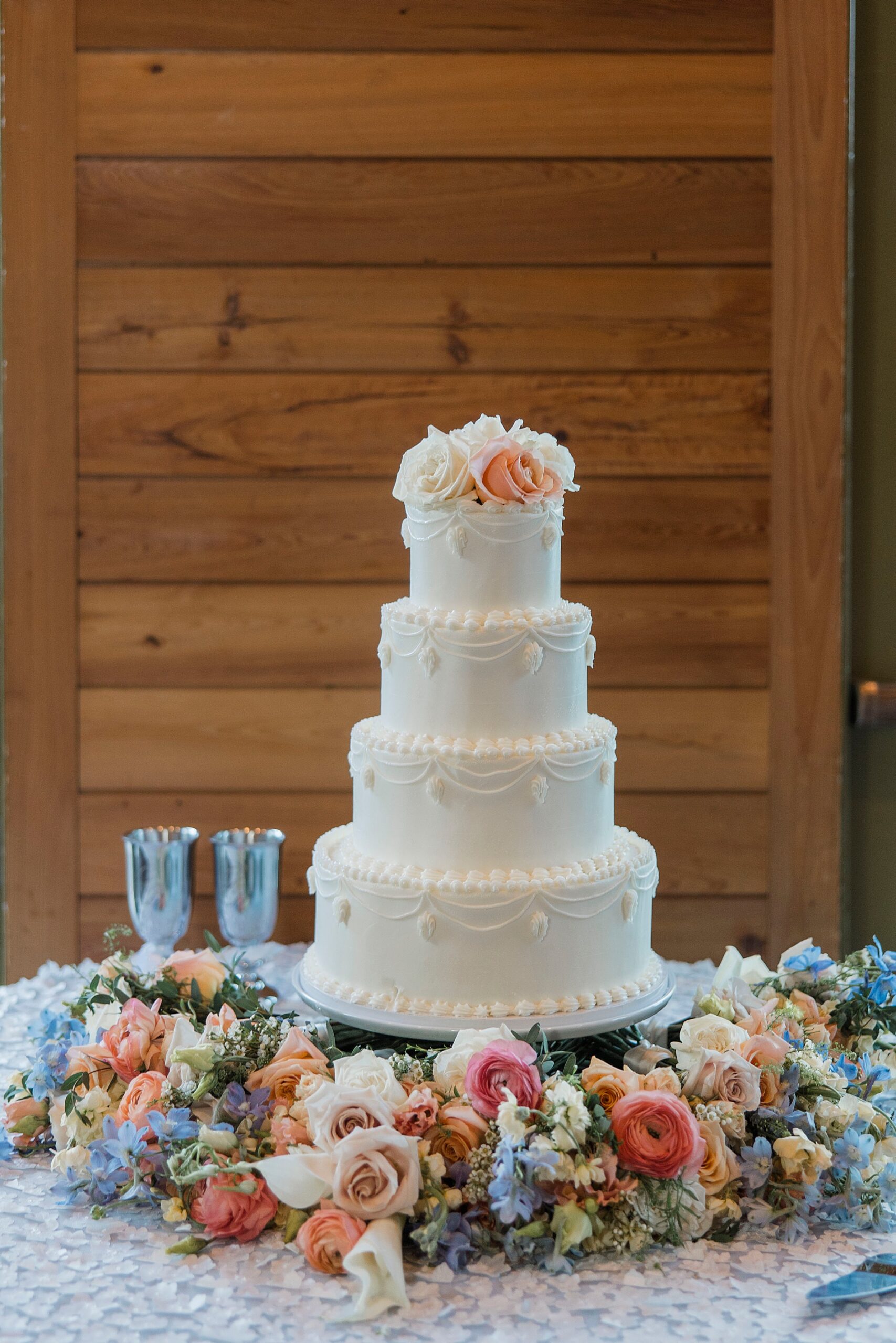 wedding cake surrounded by fresh. soft florals