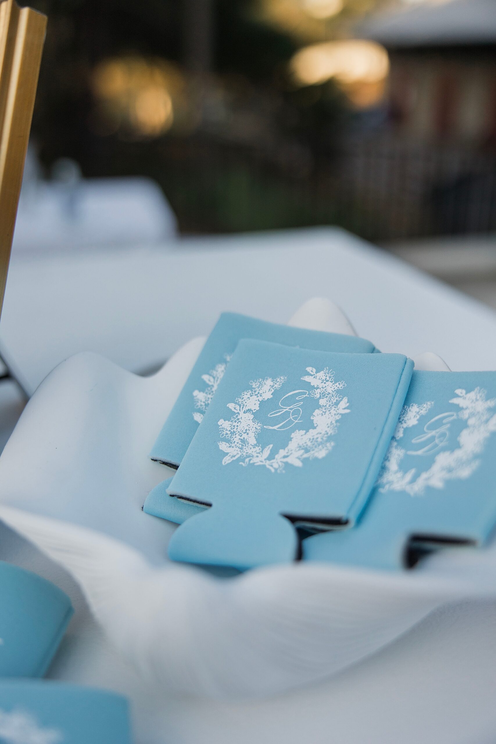 custom koozie favors in dusty blue with white monogram 