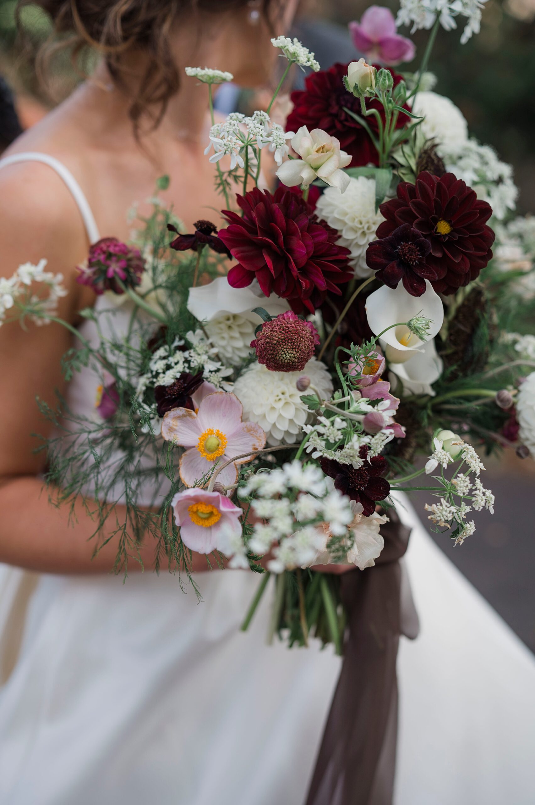 bridal bouquet with dark red and white organic flowers 