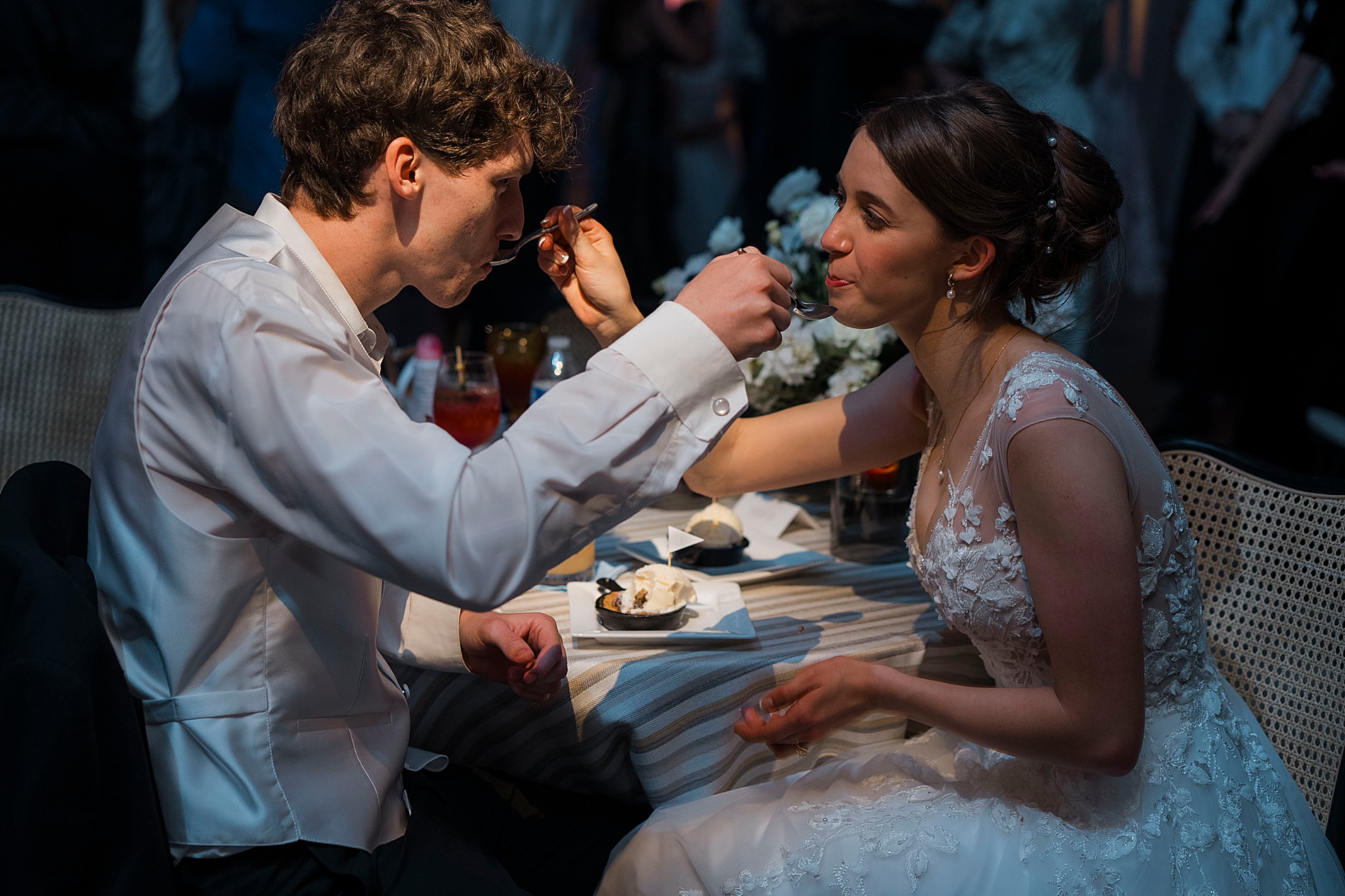 couple feed each other dessert