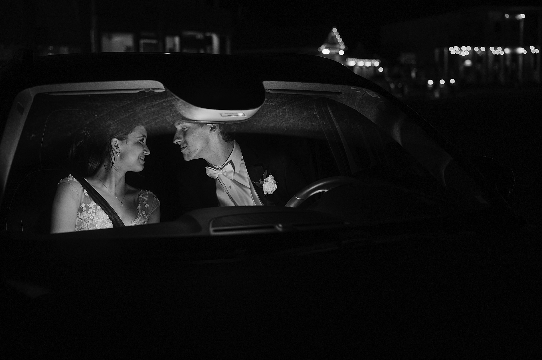 newlyweds exit wedding in car
