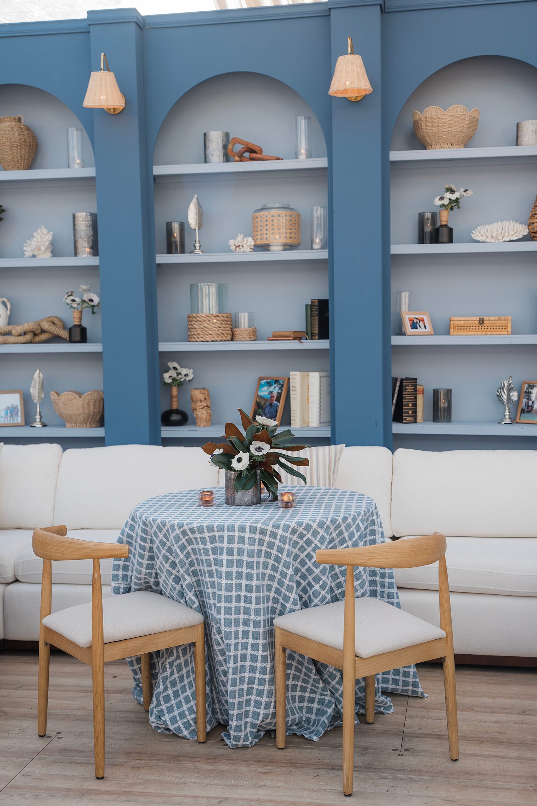 blue bookshelf displaying family heirlooms and pictures 