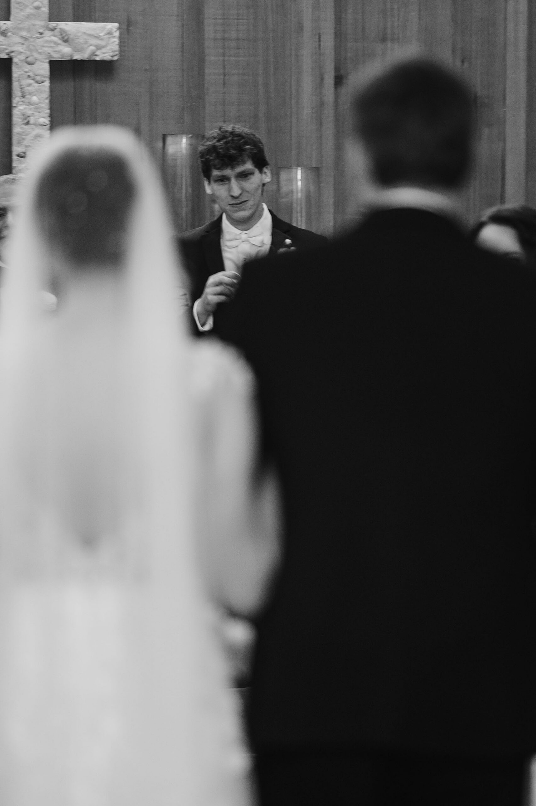 groom watching bride walk down the aisle 