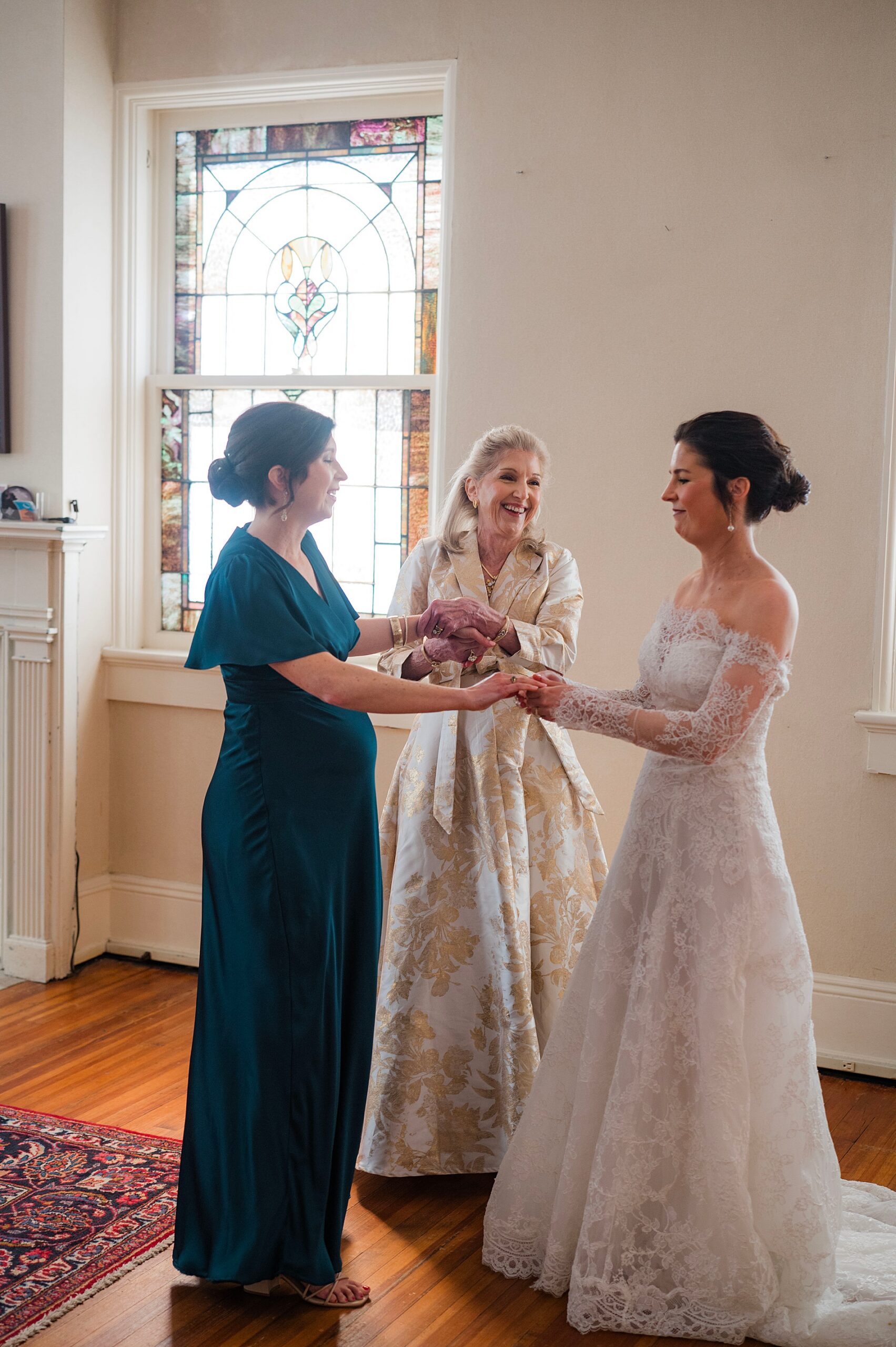 heartfelt wedding photography of bride with mom and sister