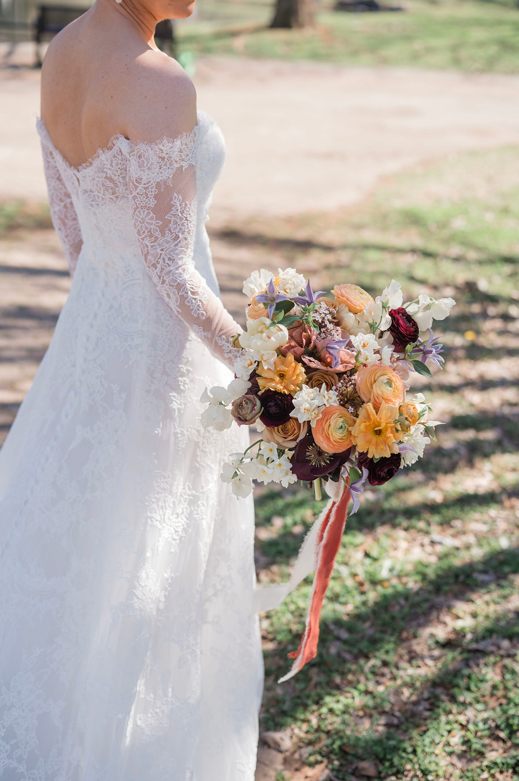 lace covered wedding dress and bridal bouquet
